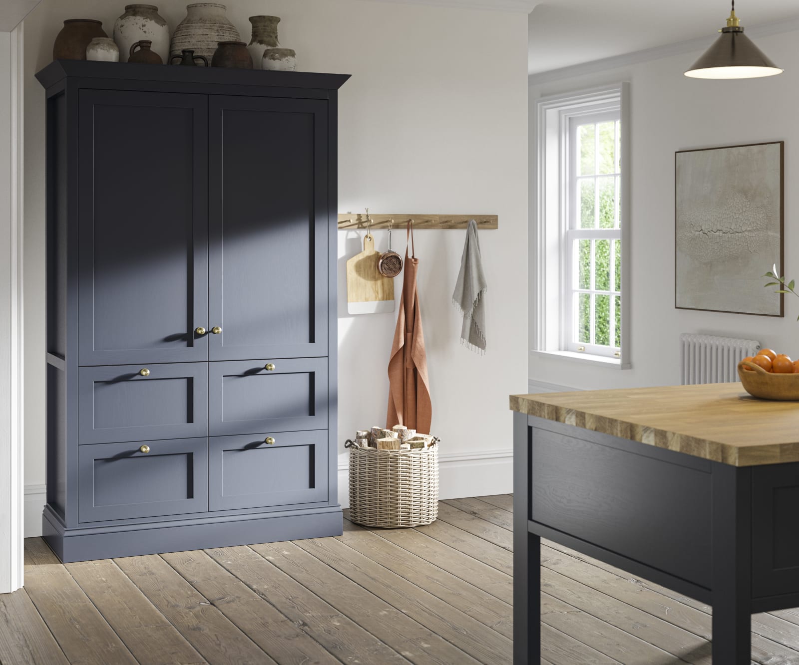 Tall shaker cabinet in dark blue shade, with handmade ceramics on top.