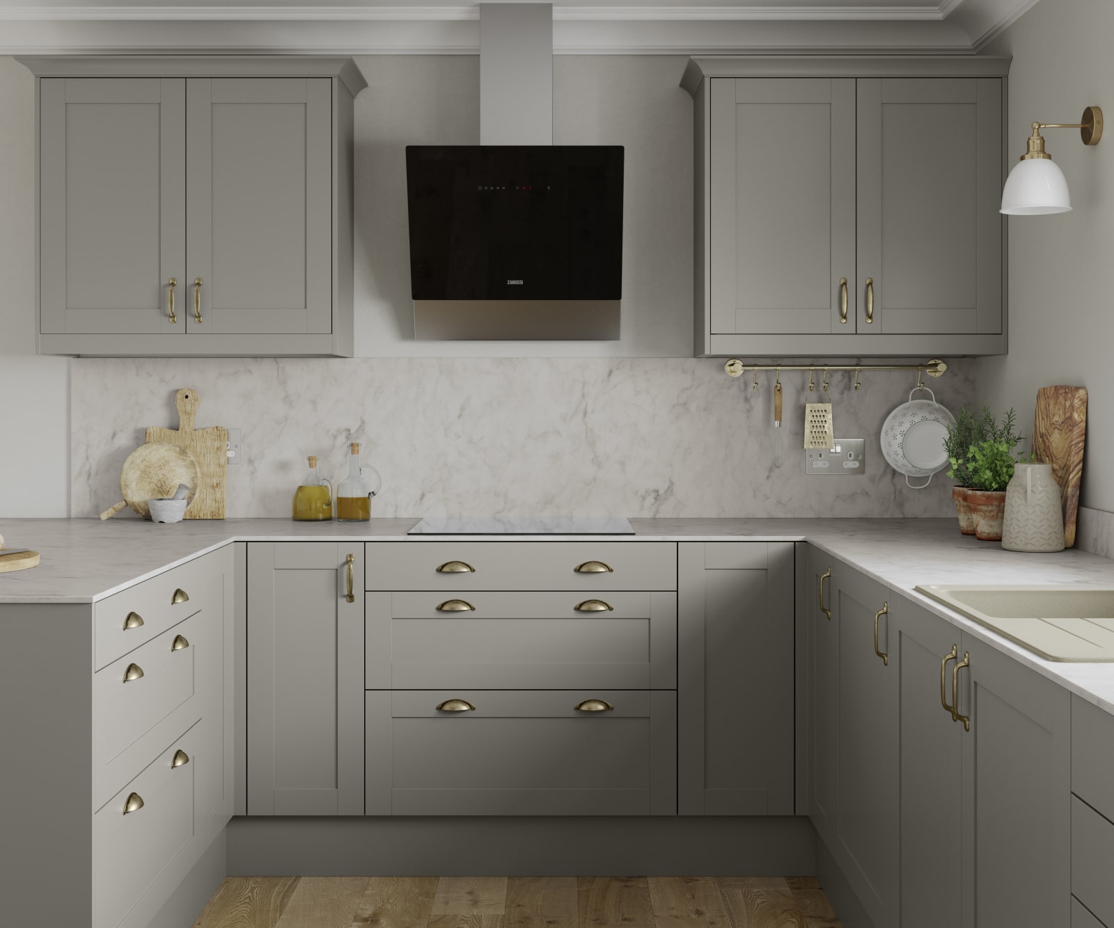 U-shape Tatton kitchen from Magnet in the shade Pebble, brass handles and accessories and a light marbled worktop with matching splashback.