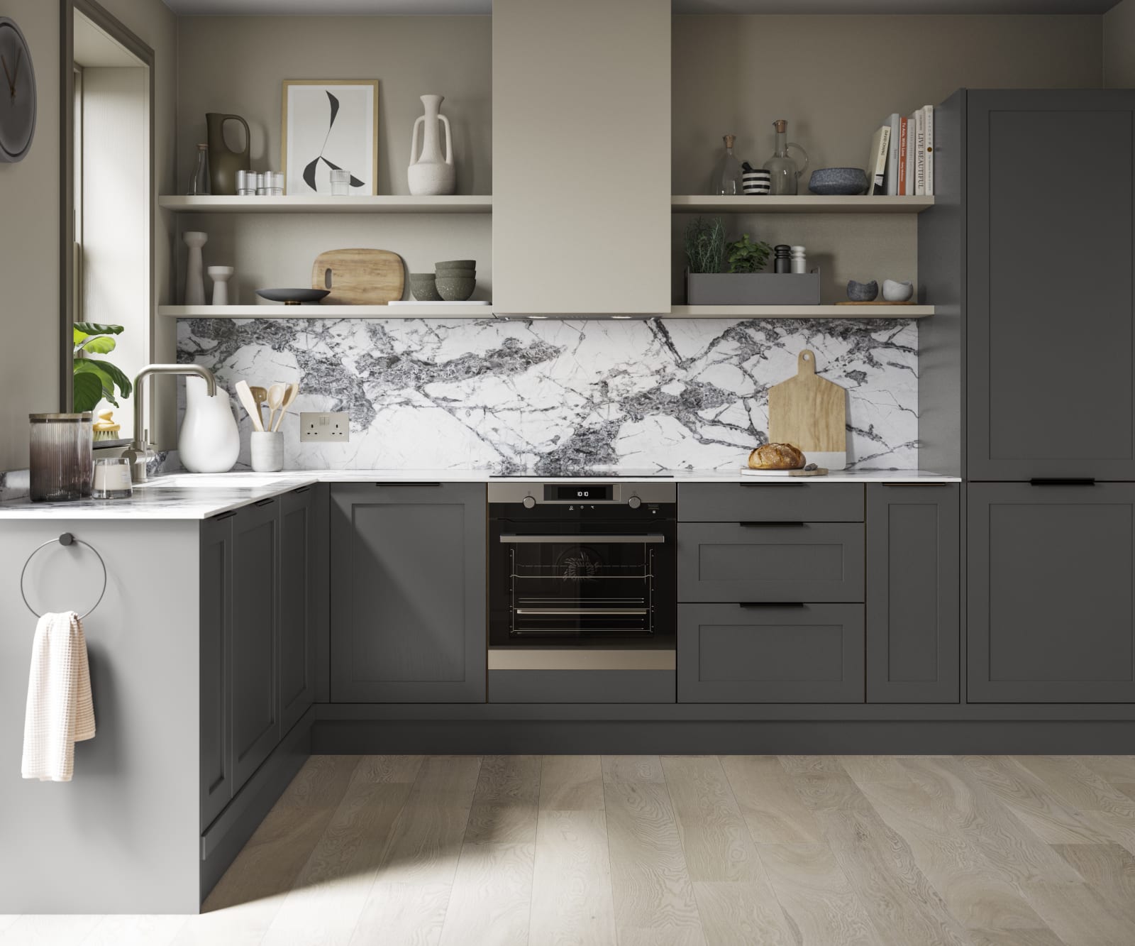 A dark grey Shaker kitchen with Charcoals cabinetry, paired with marble splashback and stylish black handles.