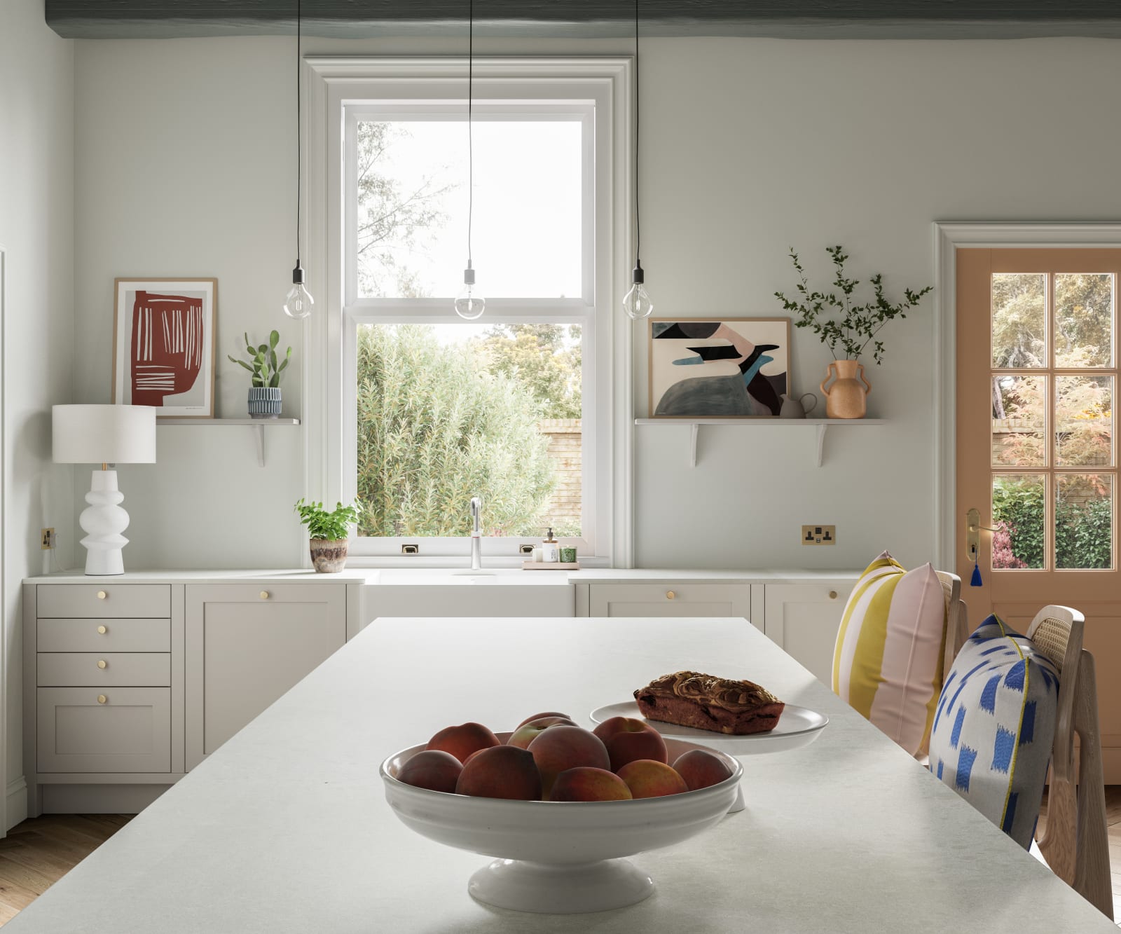 View of kitchen island in traditional shaker kitchen Wardley with modern shades and decorations.