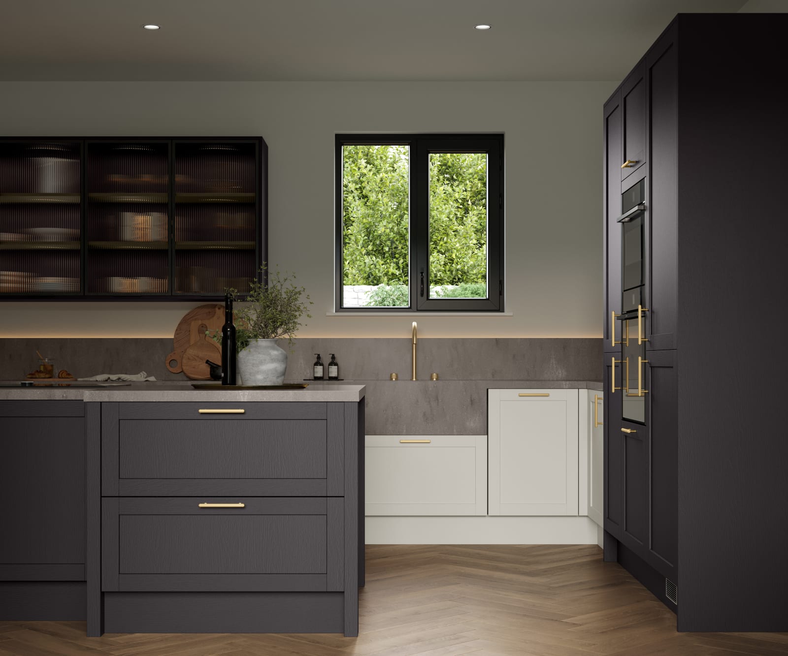 A Shaker kitchen in a contemporary kitchen, showing a mix of cabinet colours including Graphite and Limestone.