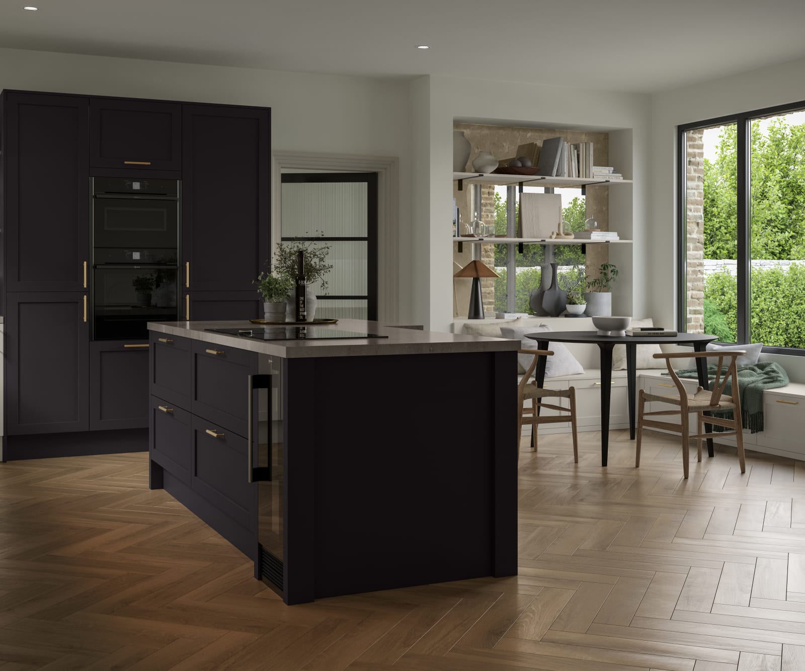 The Ambleside kitchen in a dark Graphite shade, in a contemporary kitchen setting with wooden herringbone flooring.