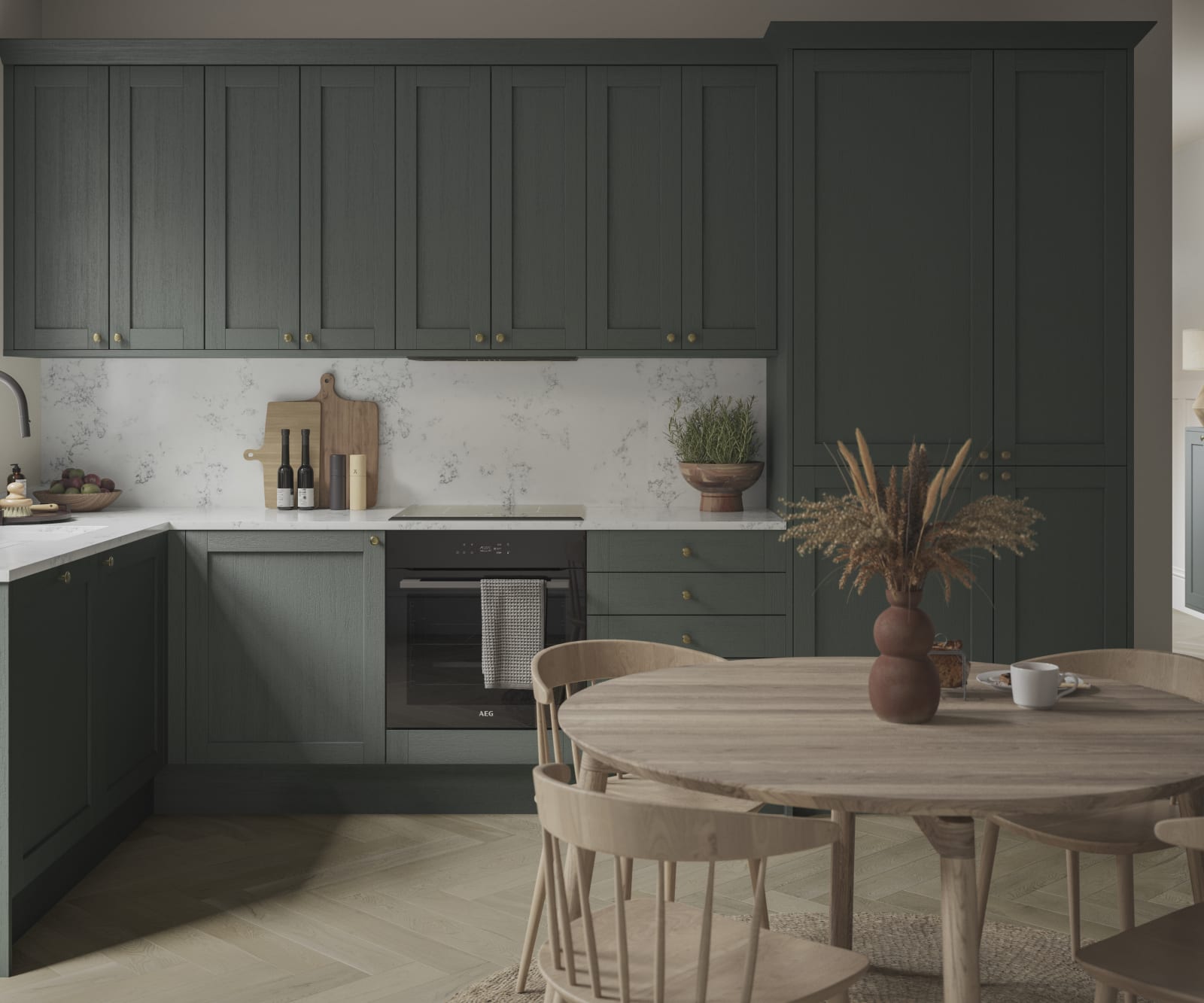 A Shaker kitchen with dark green cabinets and a wooden table.