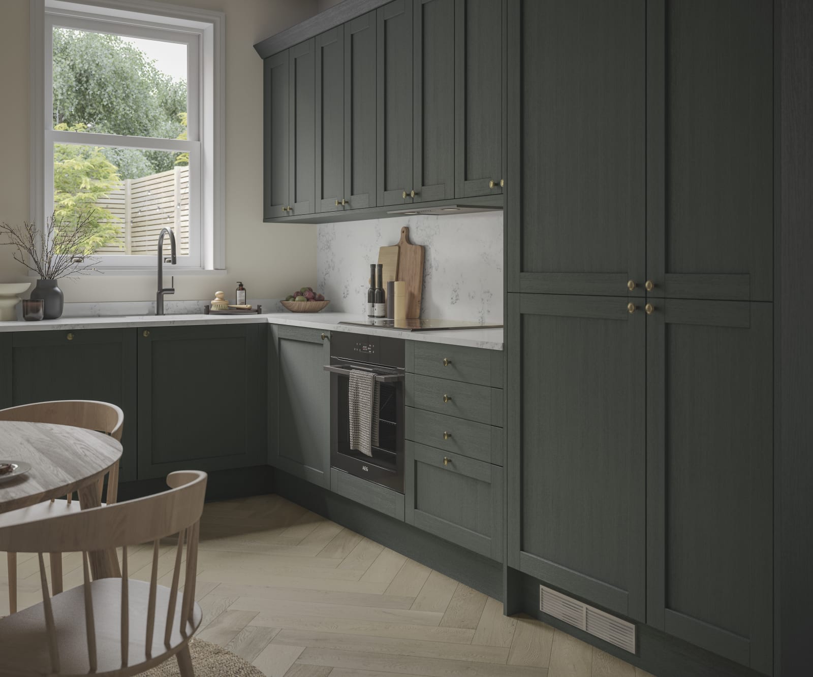 A contemporary Shaker kitchen in Ambleside with dark green cabinets and a wooden table.