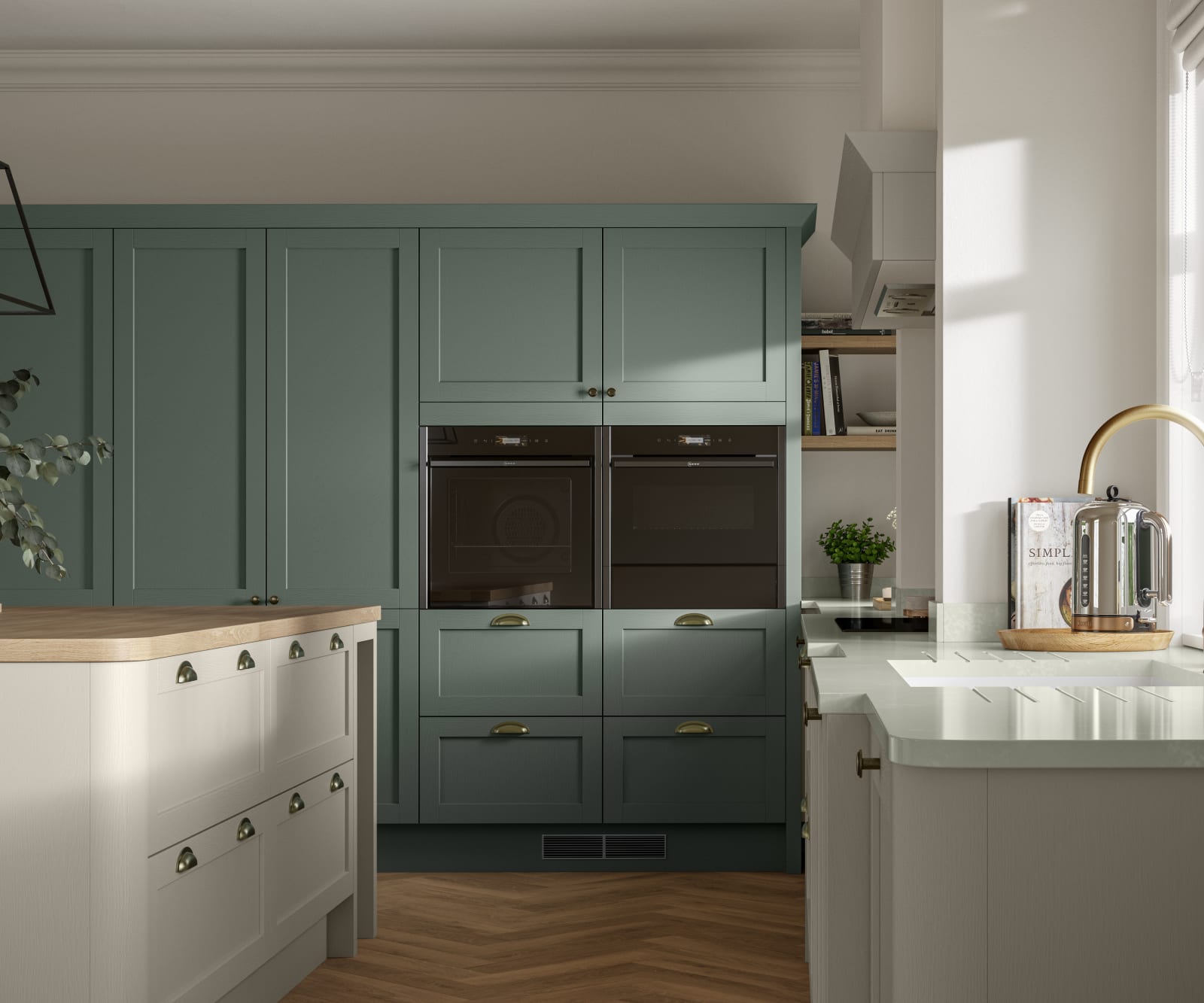 A contemporary kitchen with green and cream cabinets in Ambleside, featuring a Shaker-style design.