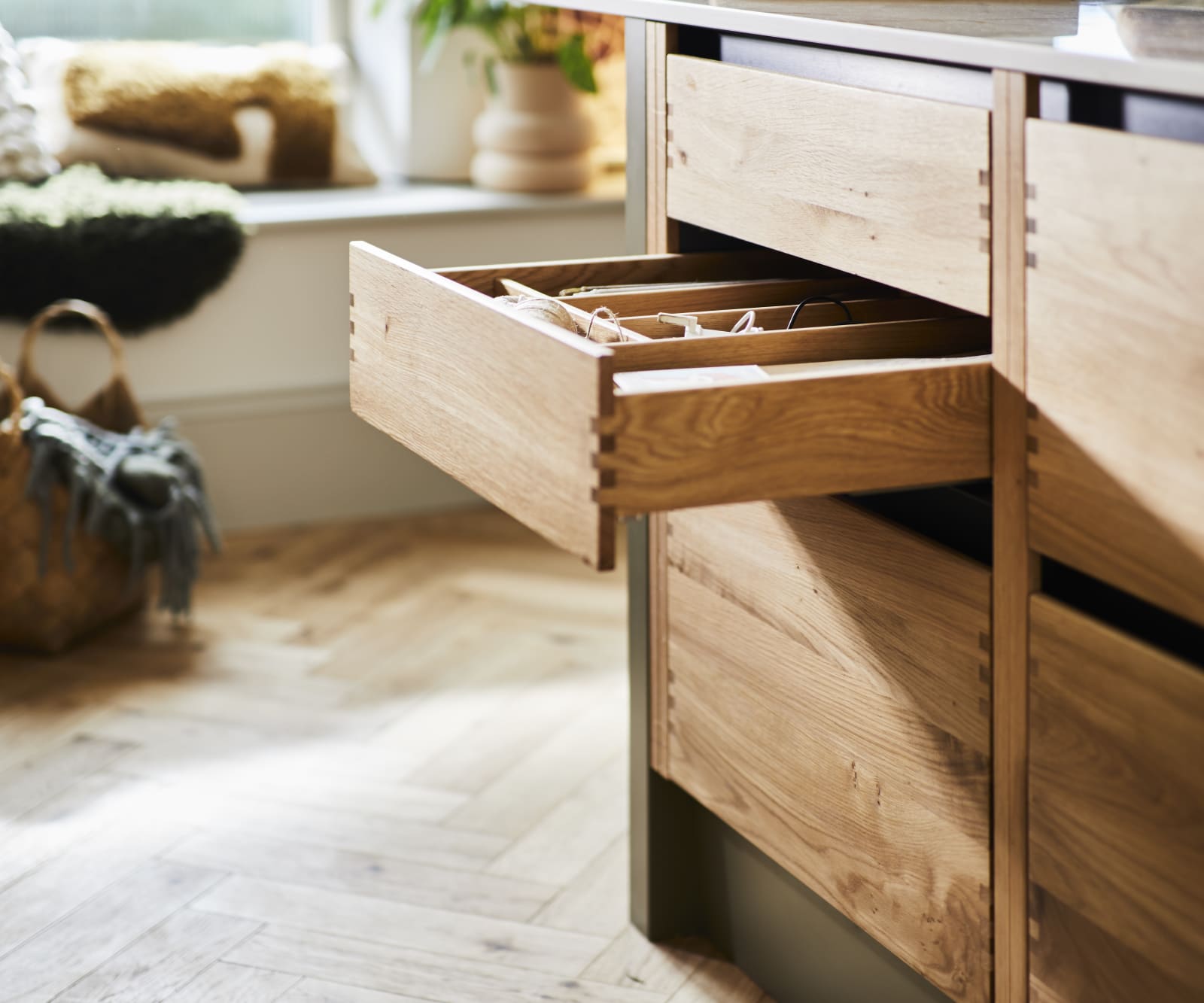 Opened oak drawer with oak inserts in Nordic Craft cabinetry in Magnet customer Jen's kitchen.