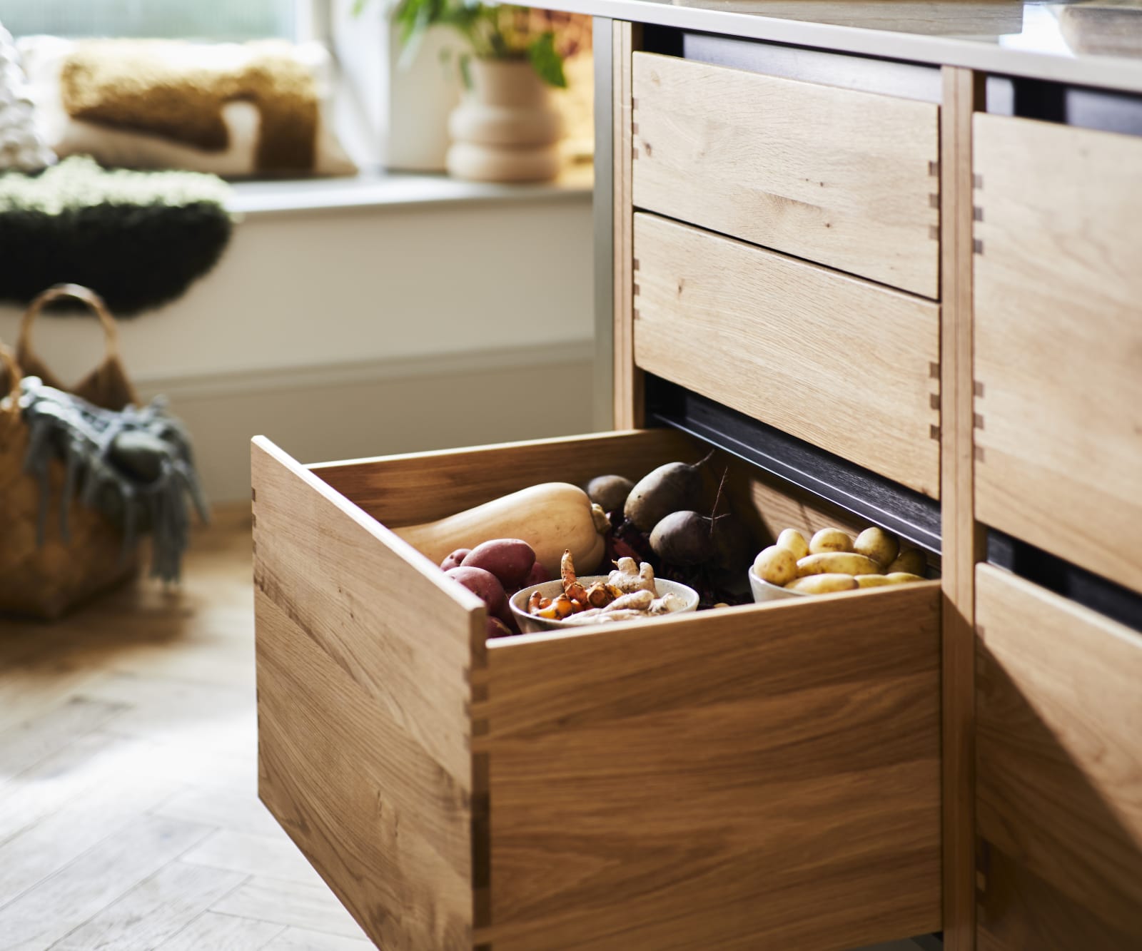 Opened large lower drawer in Nordic Craft cabinet, filled with fresh vegetables.