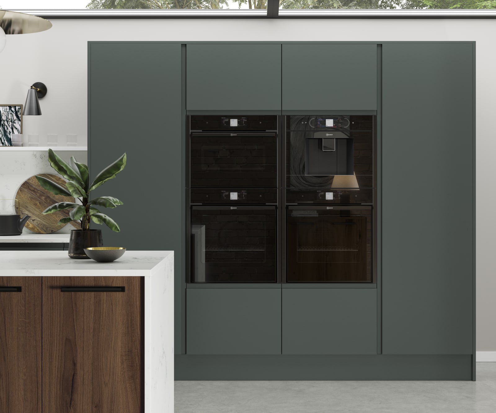 Black appliances integrated into full-height door units from Magnet's Duxbury range, seen in a rich dark green.