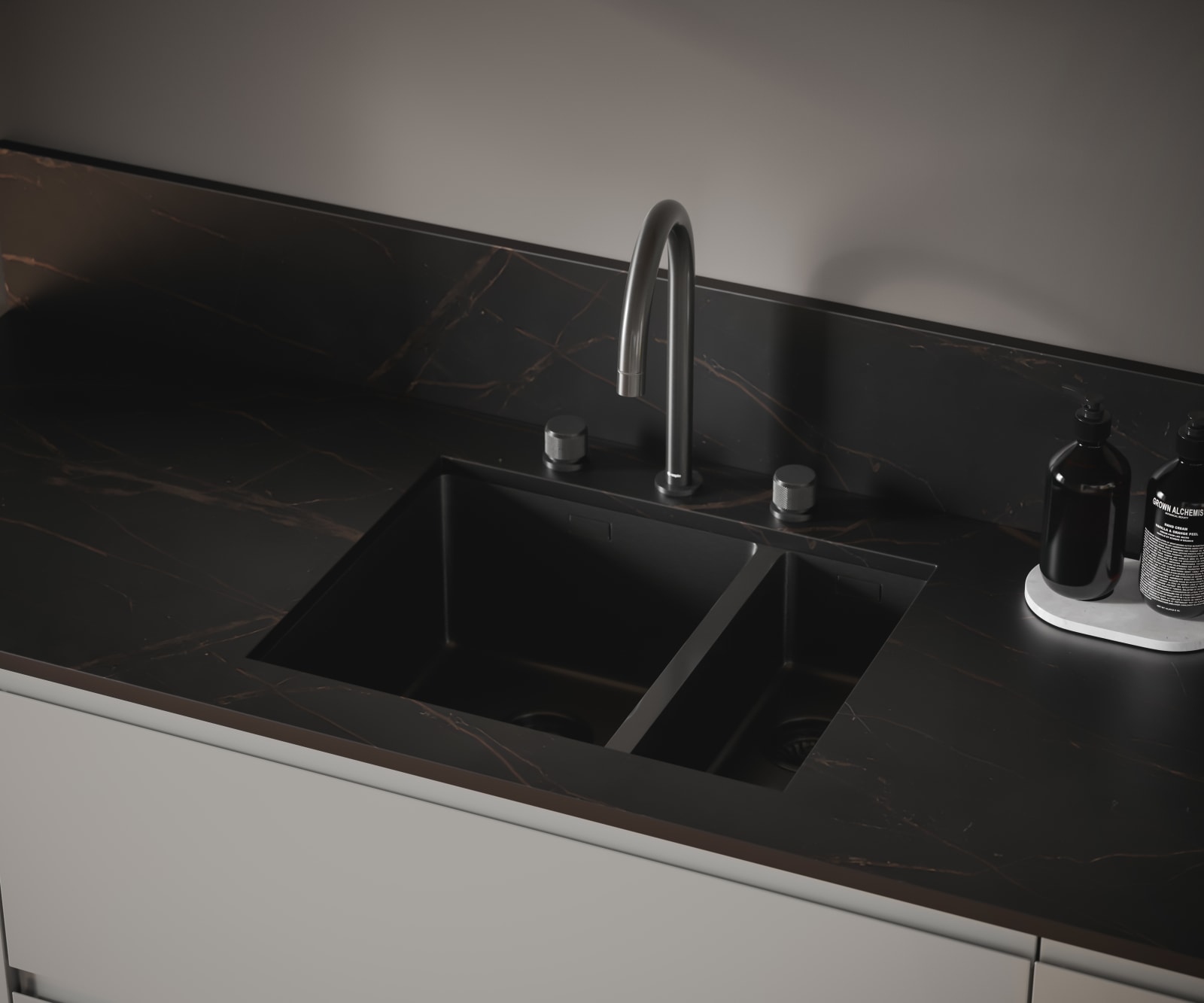 The J-pull handle of Magnet's Duxbury kitchen range is seen with a dark kitchen worktop and modern integrated double sink and arched tap.