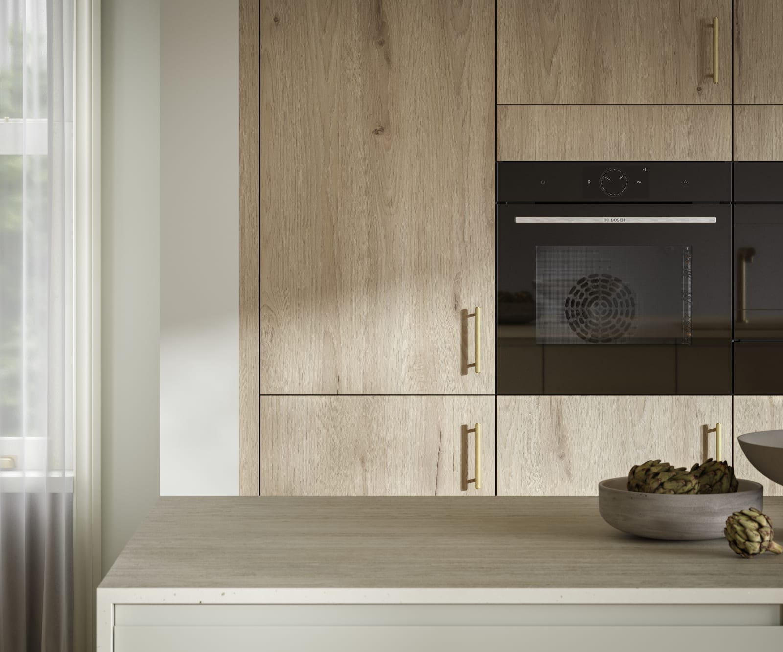 Magnet's modern Portobello kitchen in a light woodgrain décor, finished with brass bar handles.