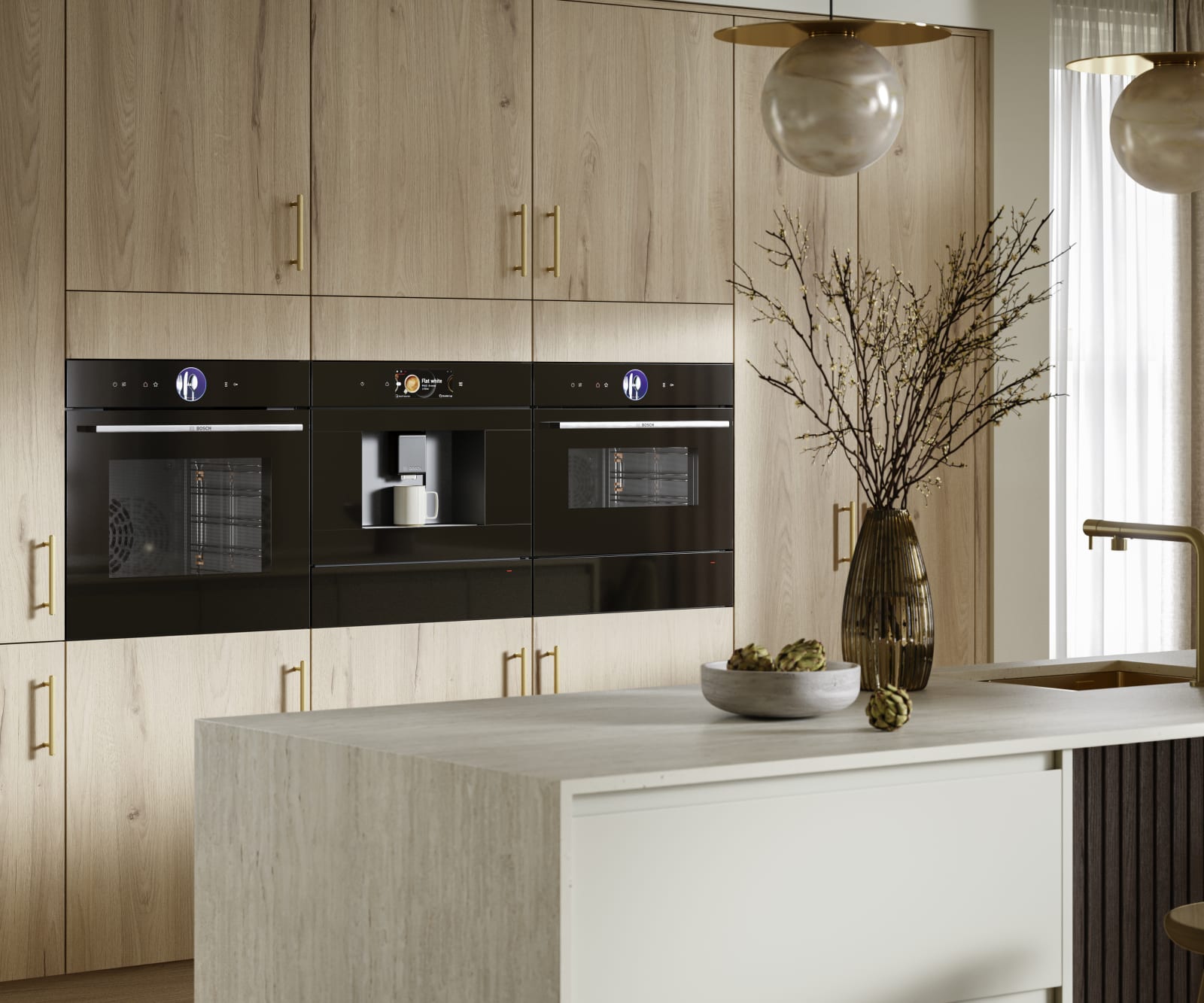 Modern Portobello kitchen cabinets in Bosco are finished with brass bar handles.