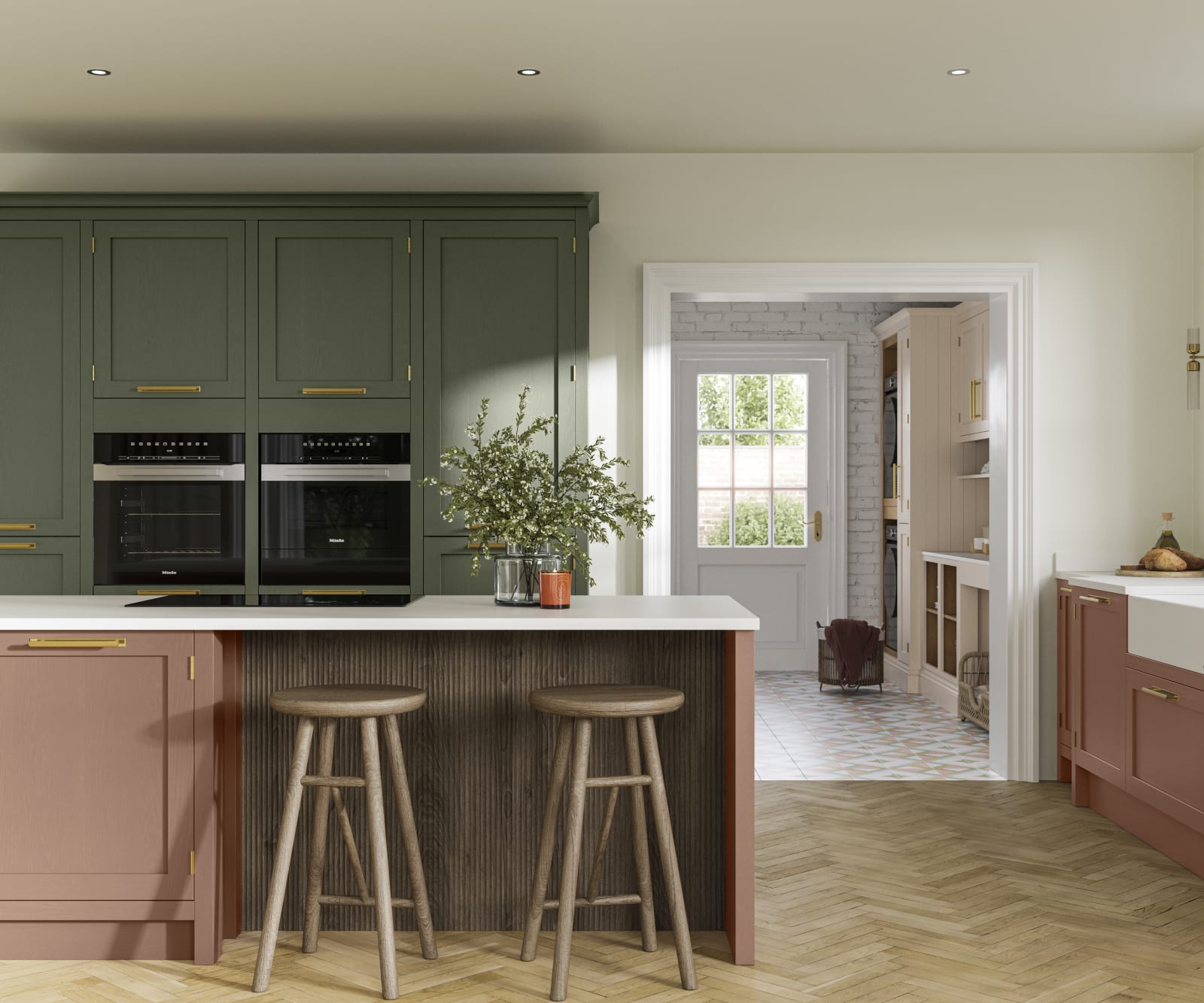 Tall Wardley kitchen cabinets  with built-in ovens, a kitchen island in shade Clay with wooden panelling by seating area and matching wooden bar stools.