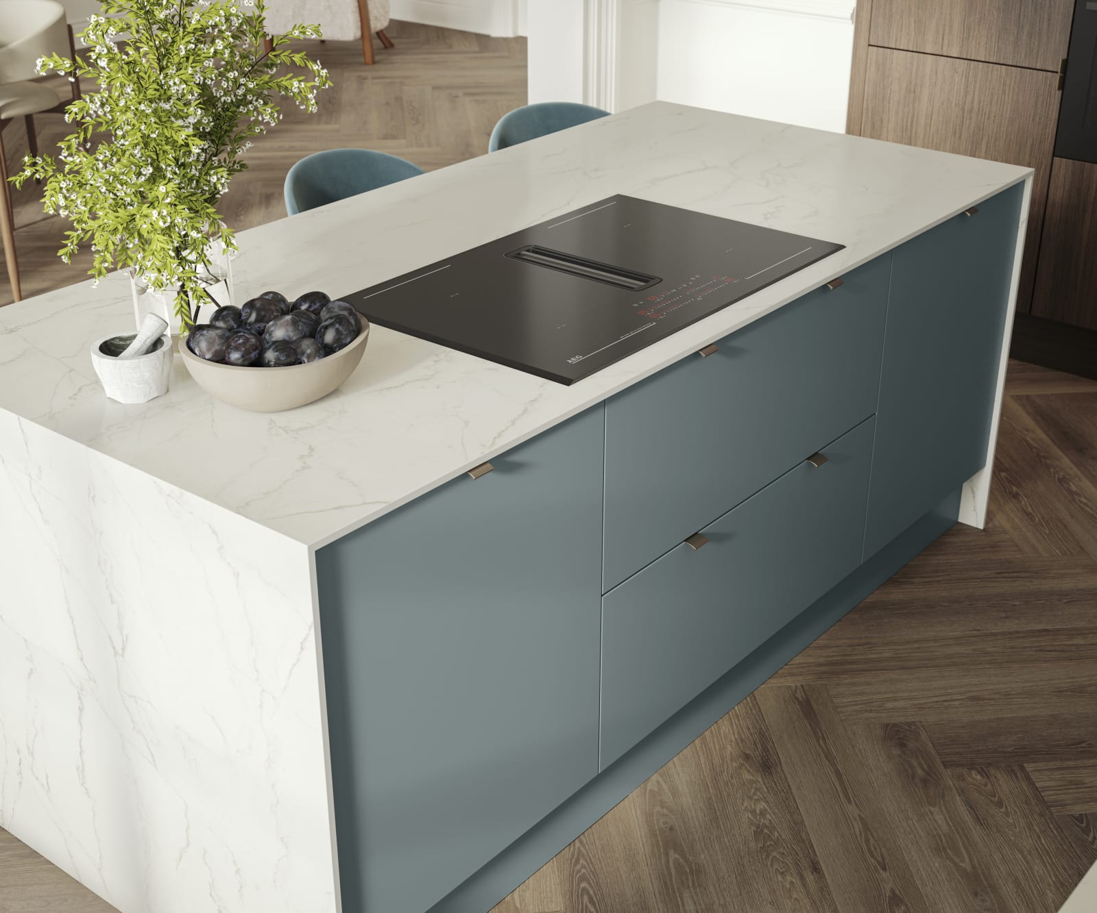 Overhead view of kitchen island with marbled dekton worktop, integrated hob and Soho Duck Blue cabinetry from Magnet.