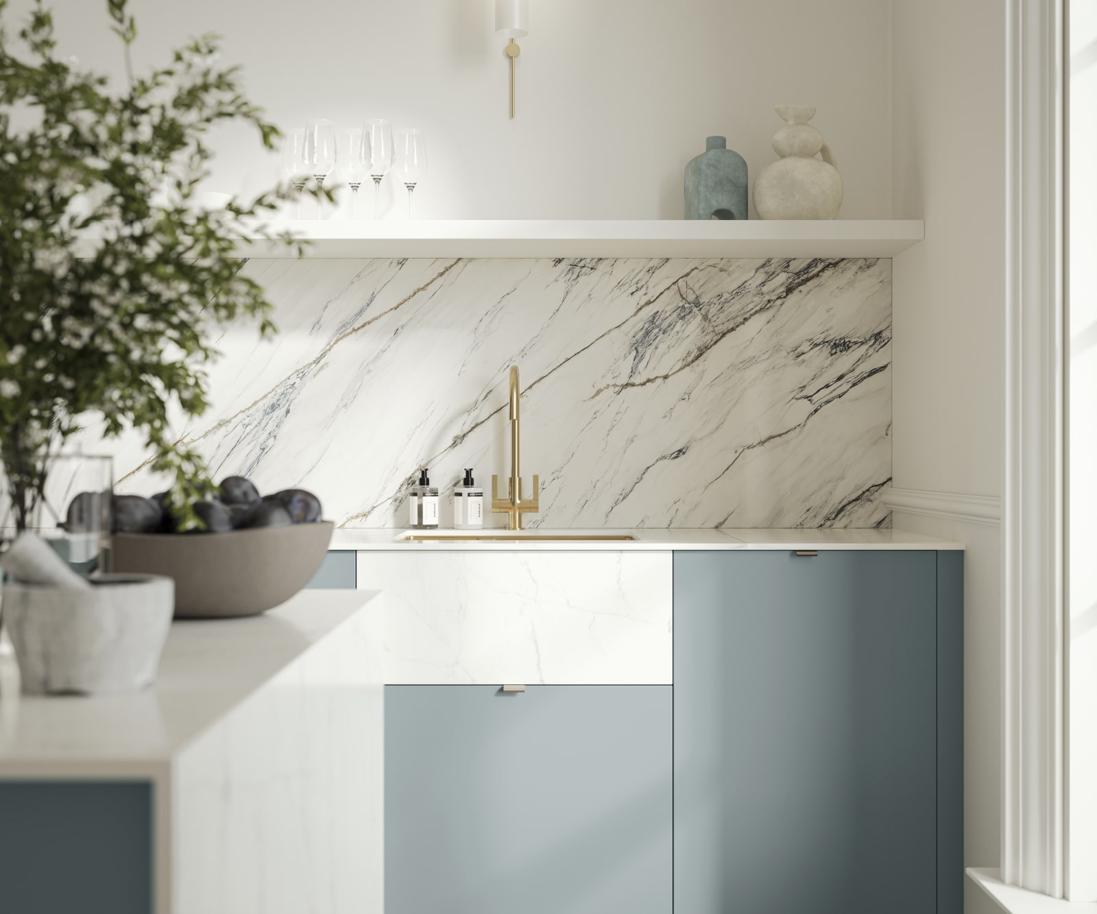 Soho Duck Blue kitchen from Magnet with white marble splashblack, paired beautifully with a bright brass tap and sink.