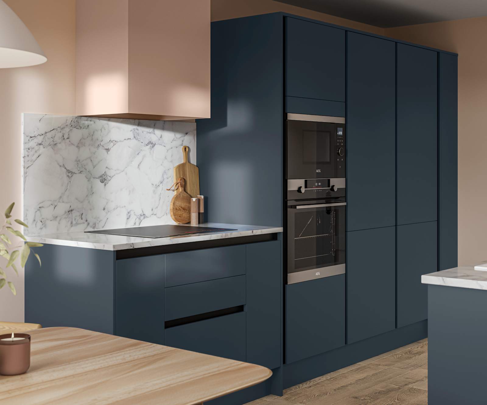 Handleless Integra Ascoli Mineral Blue, a dark blue kitchen with built-in ovens in tall cabinetry, an induction hob in white and grey marbled worktop with matching backsplash.