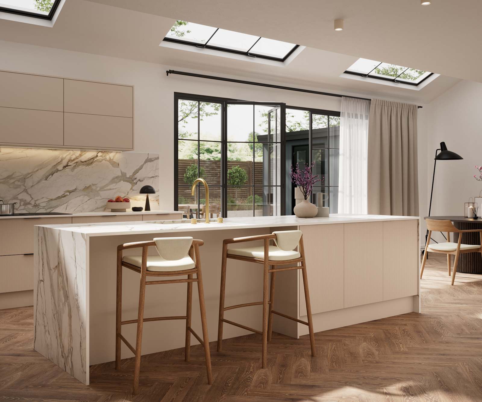 Fluted front kitchen Reed from Magnet in light warm neutral shade Shell, with a marbled splashback, worktop and decorative side on kitchen island with barstools and black handles, herringbone wood flooring.