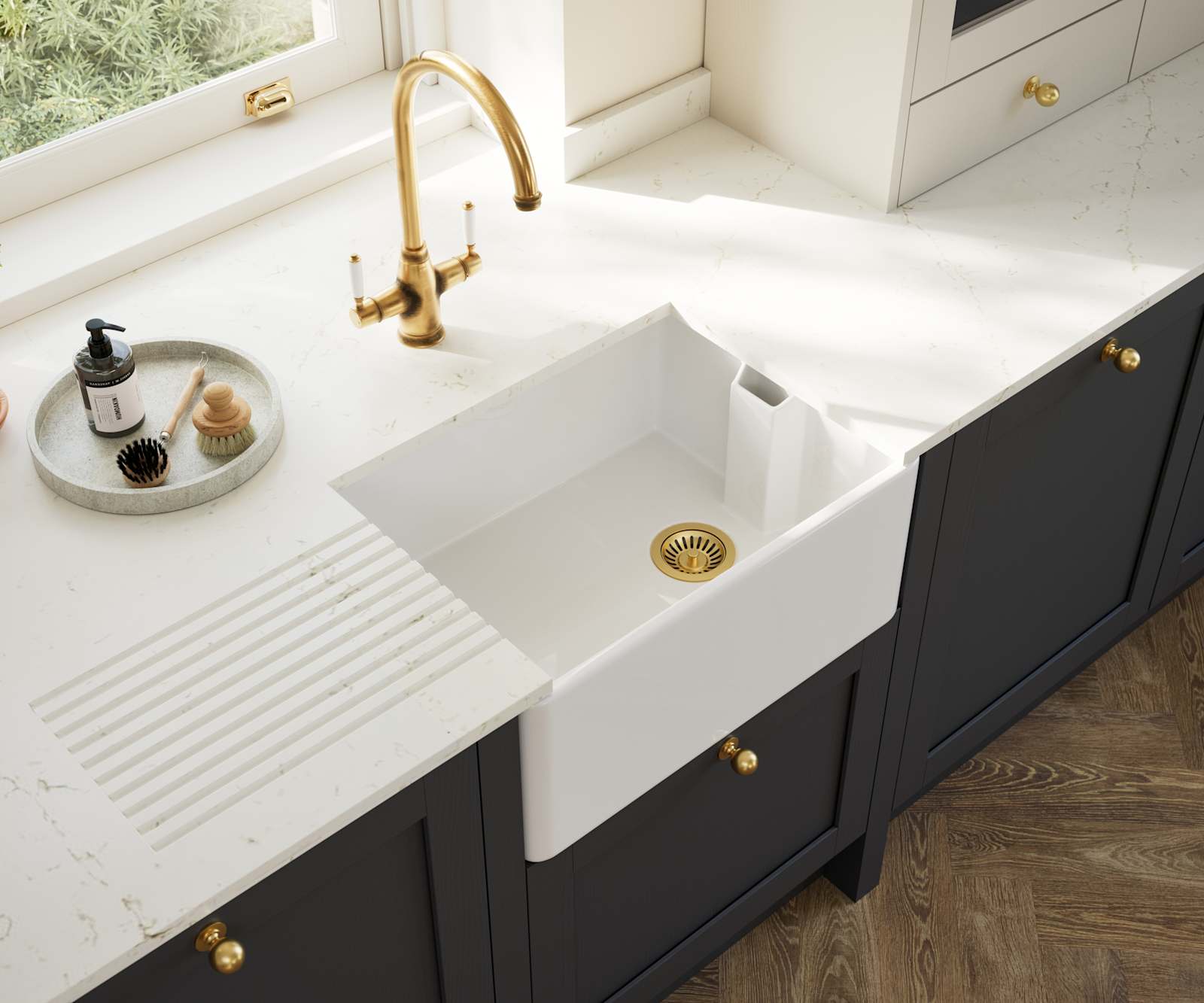 Overhead view of veramic belfast sink and brass tap in Contemporary Shaker kitchen Ambleside from Magnet in deep blue shade Lake with beige tall cabinets