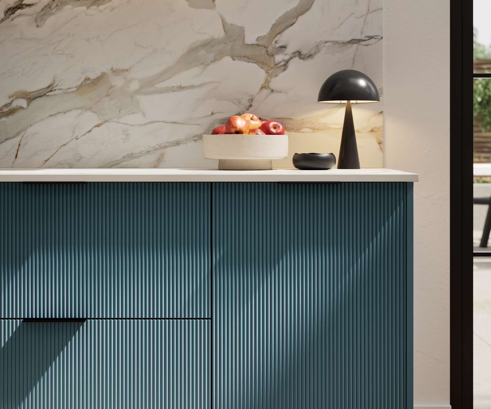 Fluted front kitchen Reed from Magnet in rich blue shade Carrington Blue, with a marbled splashback and black handles, herringbone wood flooring.