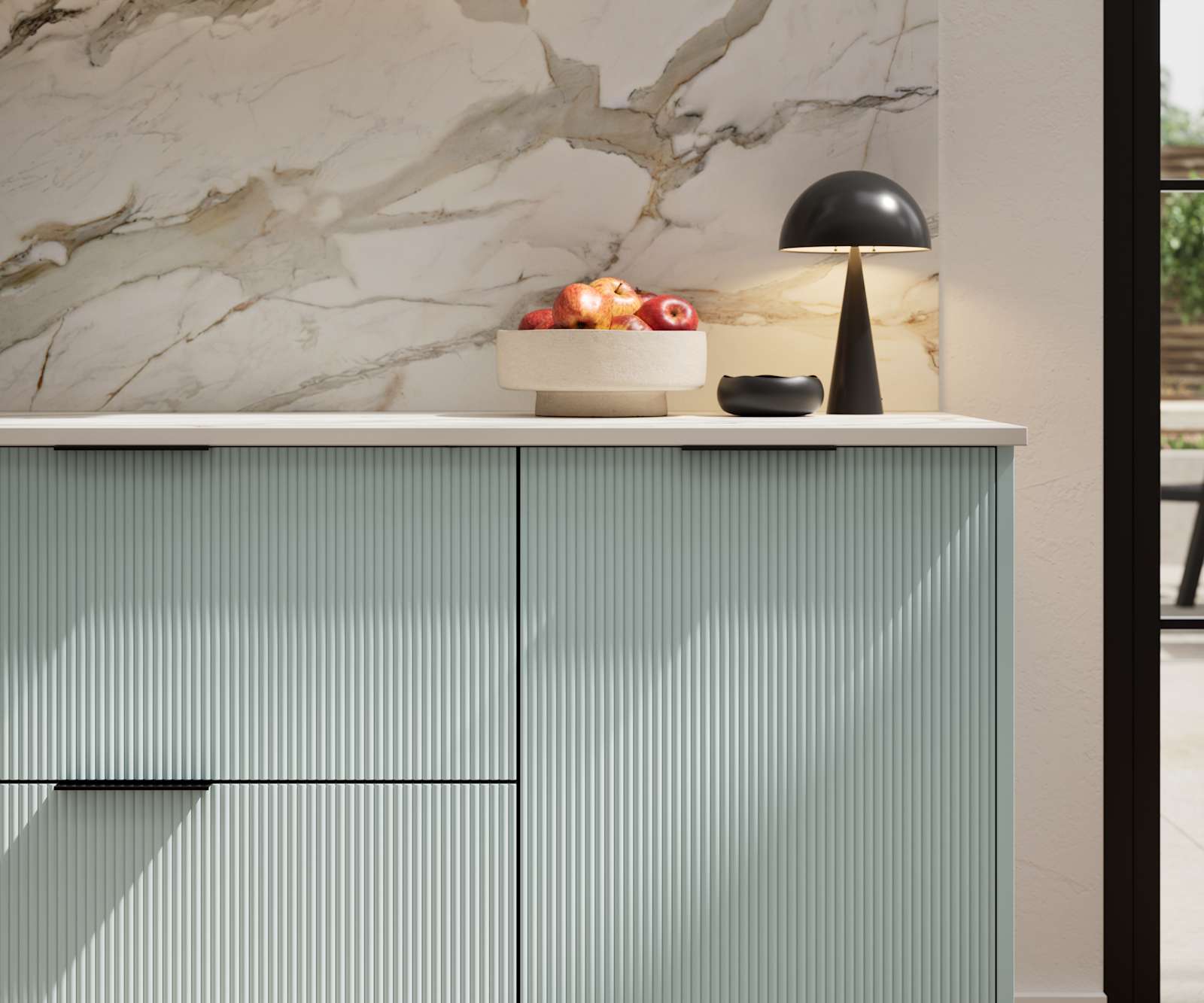Fluted front kitchen Reed from Magnet in bright blue shade Sky, with a marbled splashback and black handles, herringbone wood flooring.