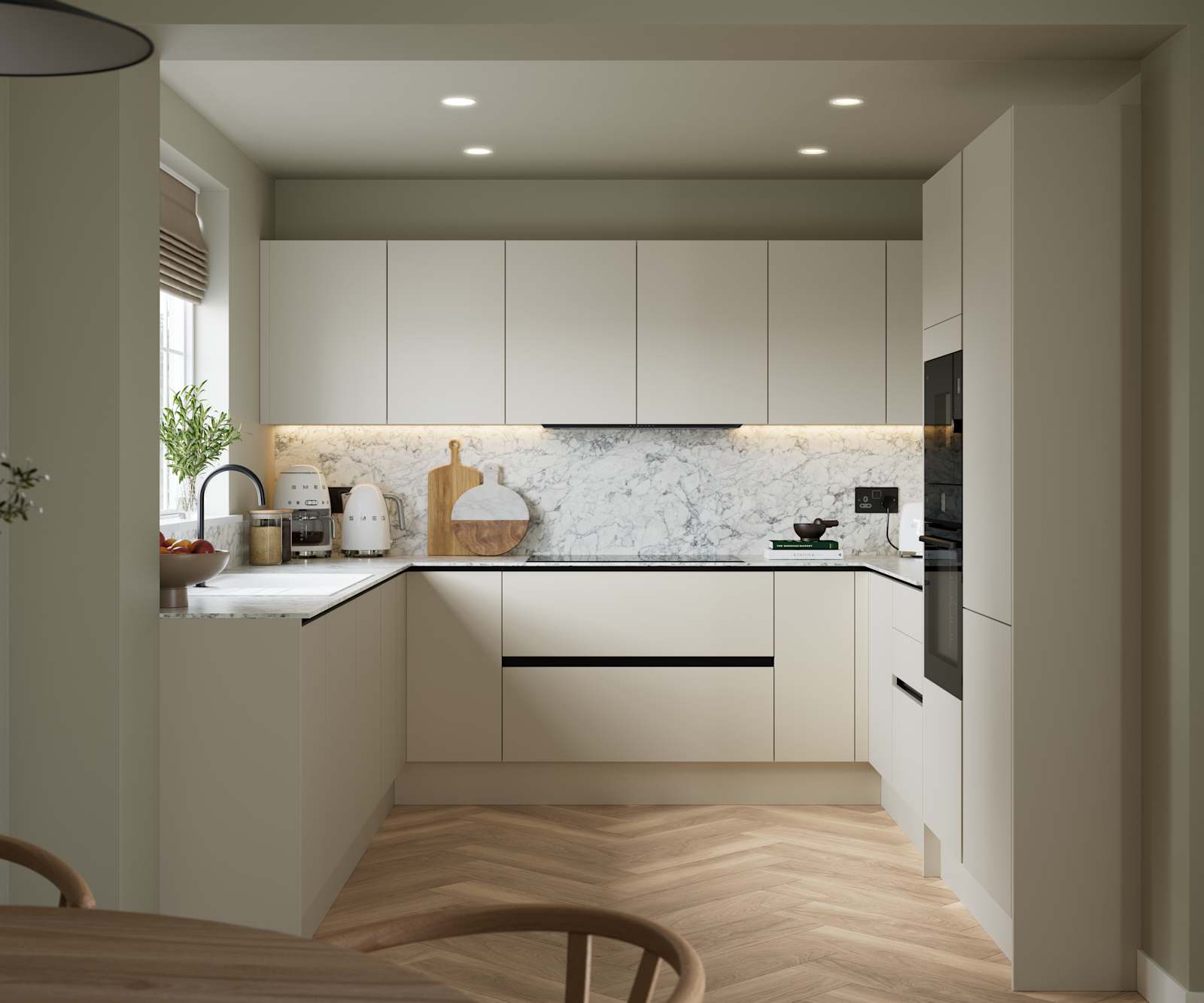Open plan light neutral shade fluted kitchen with integrated appliances, white and grey marble worktop and upstand. Herringbone wood flooring.