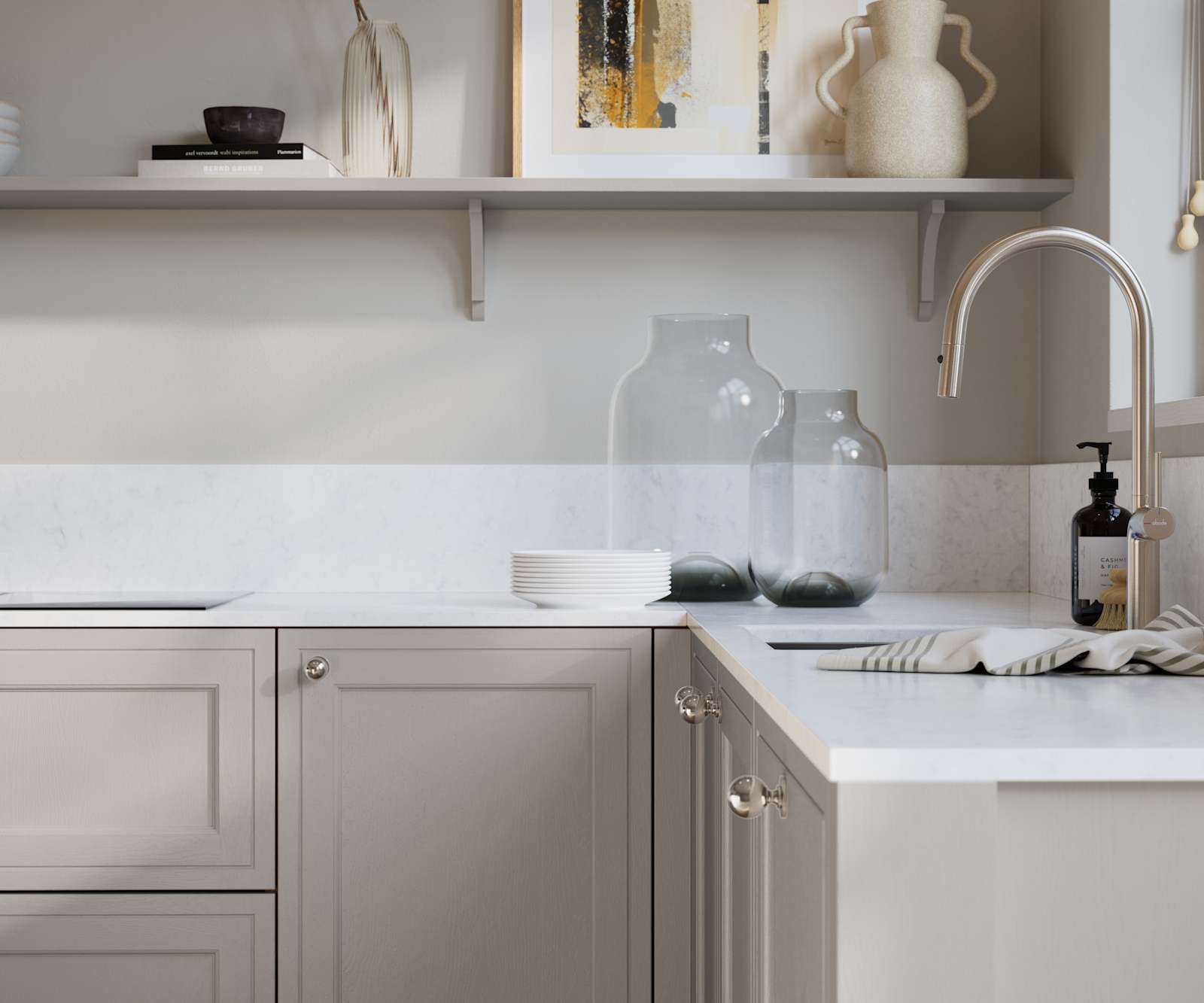 Bewdley Dove Grey painted wood grain Shaker kitchen cabinetry with steel knobs, steel tap, white marbled worktop and matching backsplash, an open shelf on the wall above cabinets with ceramics and a vase of flowers.