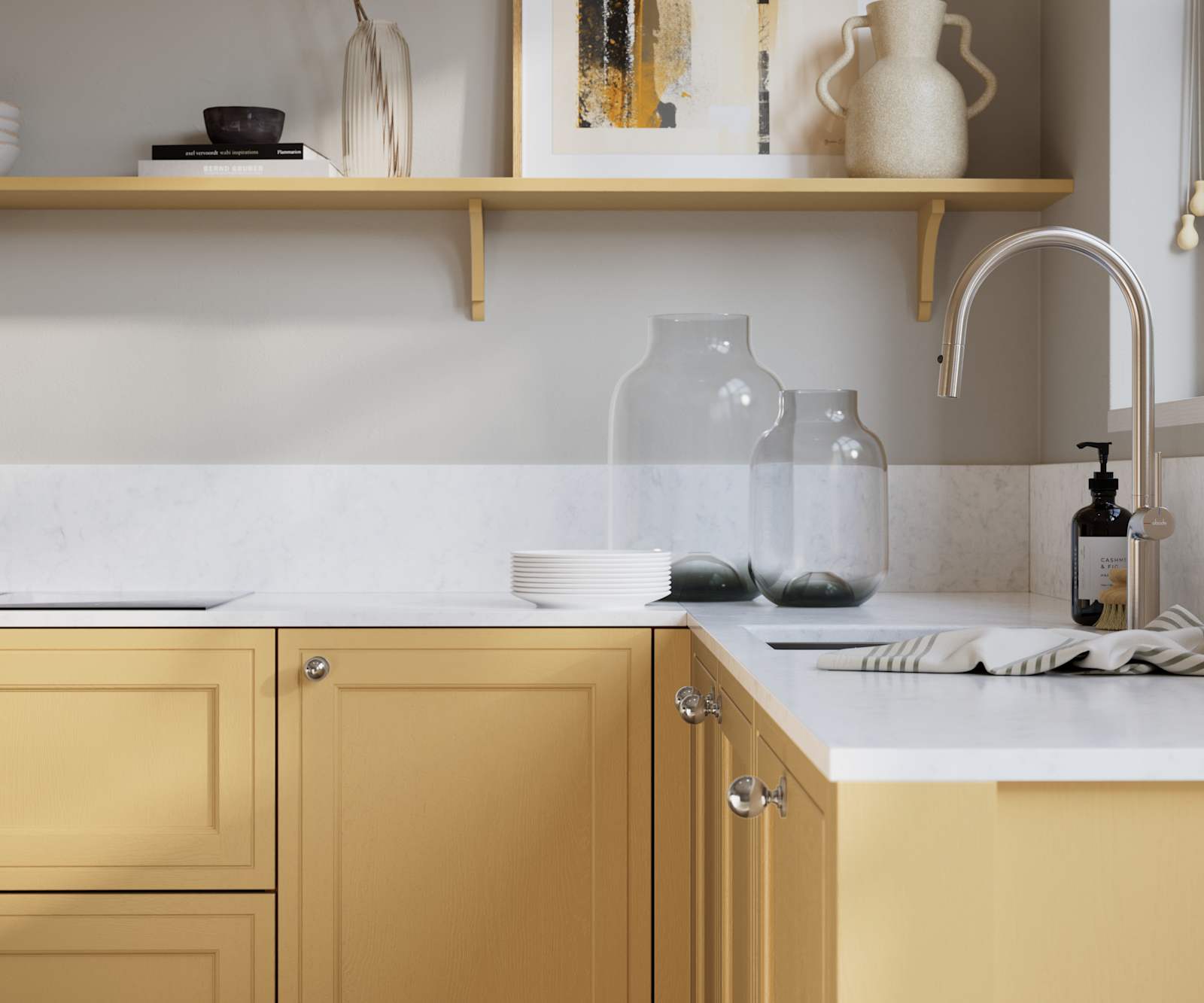 Bewdley Harvest painted wood grain Shaker kitchen cabinetry with steel knobs, steel tap, white marbled worktop and matching backsplash, an open shelf on the wall above cabinets with ceramics and a vase of flowers.