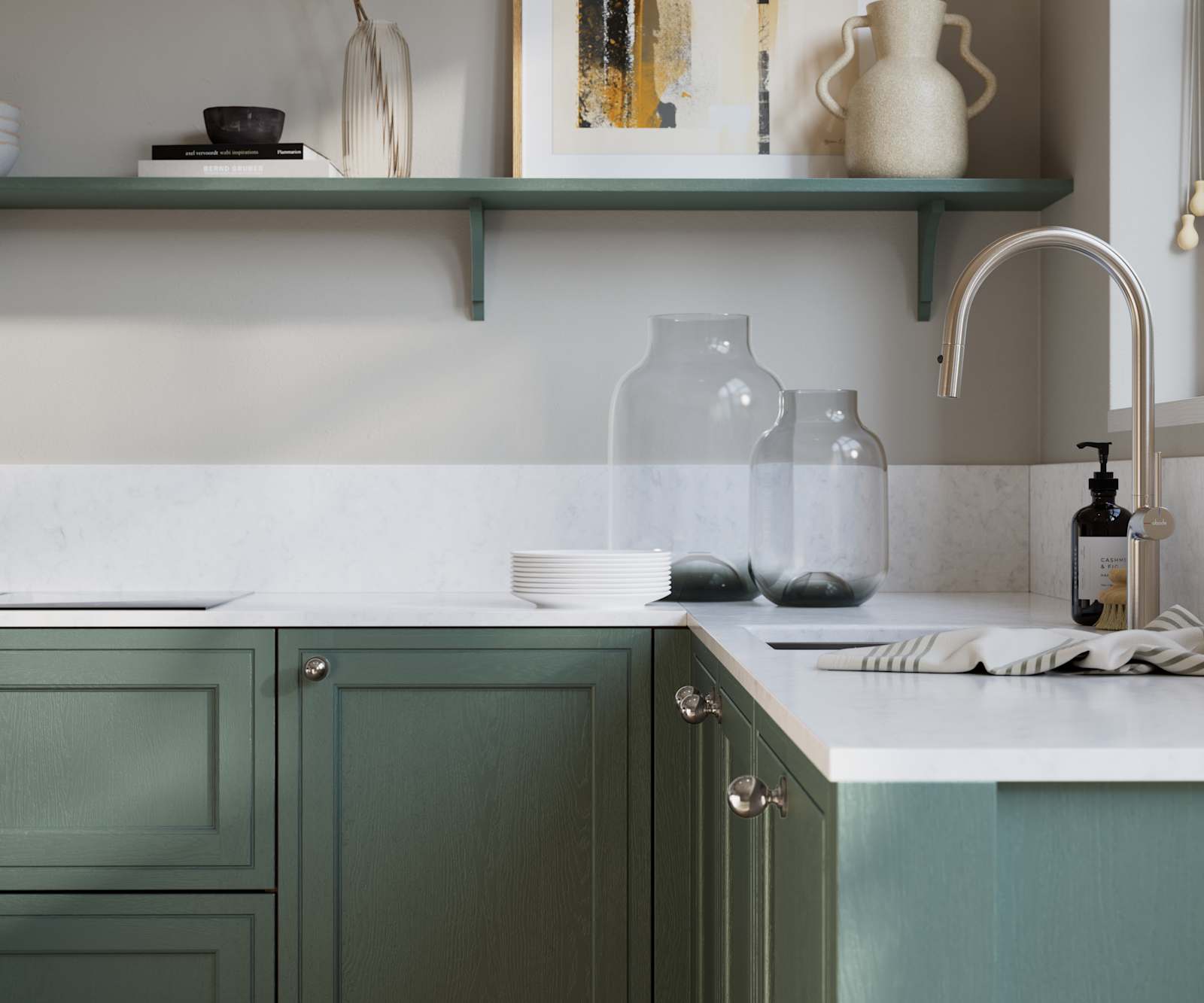 Bewdley Eucalyptus Green painted wood grain Shaker kitchen cabinetry with steel knobs, steel tap, white marbled worktop and matching backsplash, an open shelf on the wall above cabinets with ceramics and a vase of flowers.