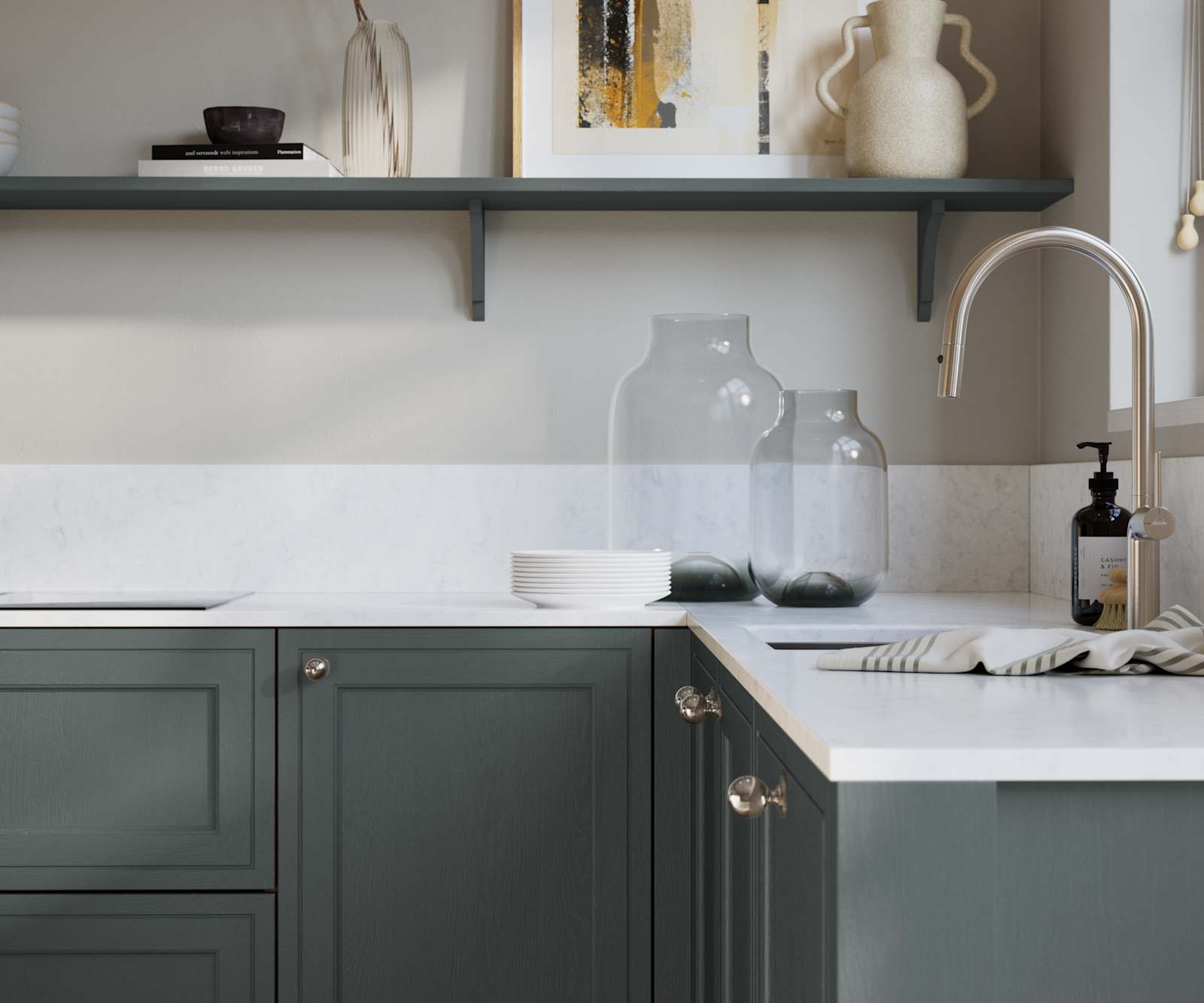 Bewdley Arboretum Green painted wood grain Shaker kitchen cabinetry with steel knobs, steel tap, white marbled worktop and matching backsplash, an open shelf on the wall above cabinets with ceramics and a vase of flowers.