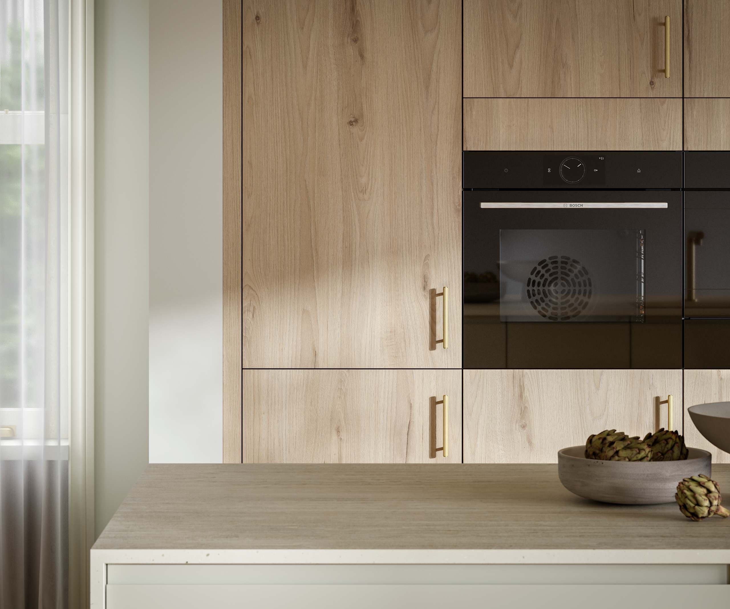 Magnet's modern Portobello kitchen in a light woodgrain décor, finished with brass bar handles.