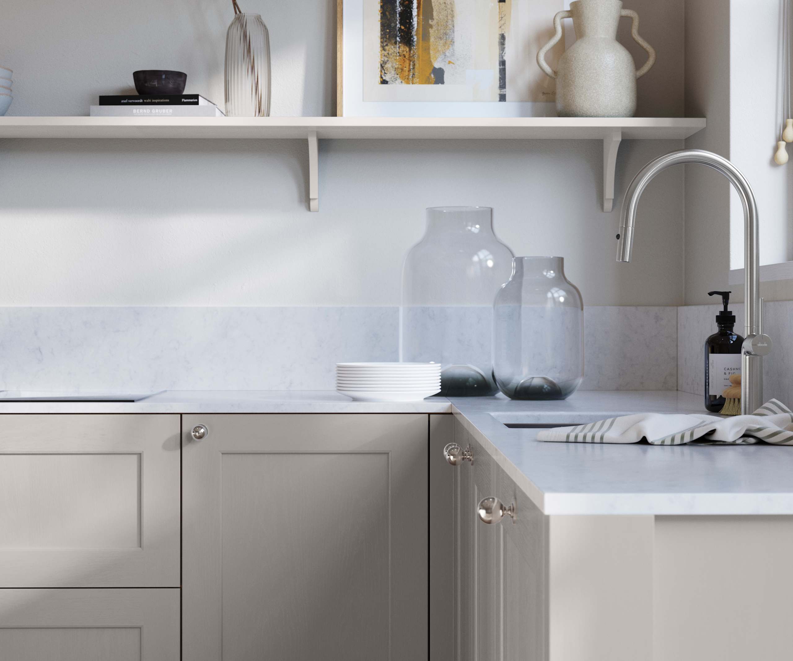 Ludlow, a traditional Shaker-style premium feel kitchen range with a visible woodgrain on its panelled doors here shown in the light grey shade Dove grey styled with steel knobs, steel tap, a white marbled worktop with matching splashback.