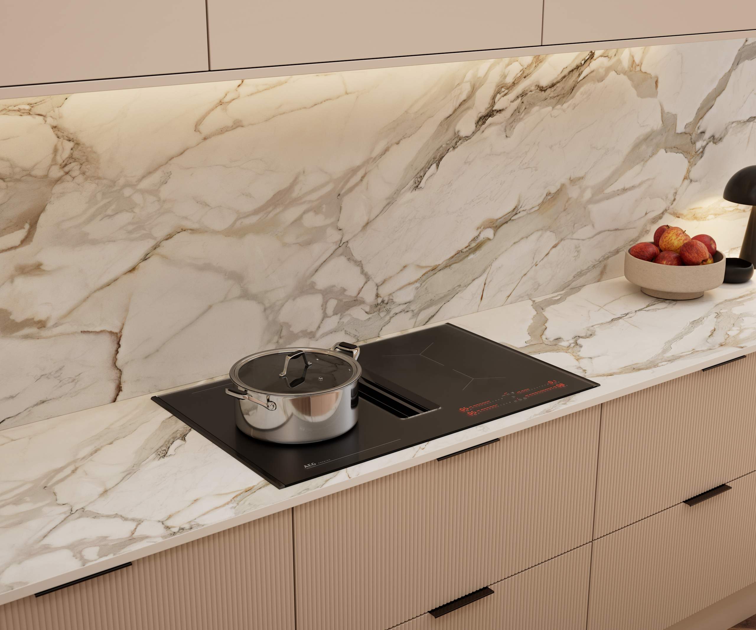 Fluted front kitchen Reed from Magnet in light warm neutral shade Shell, with a marbled splashback and worktop, induction hob and black handles