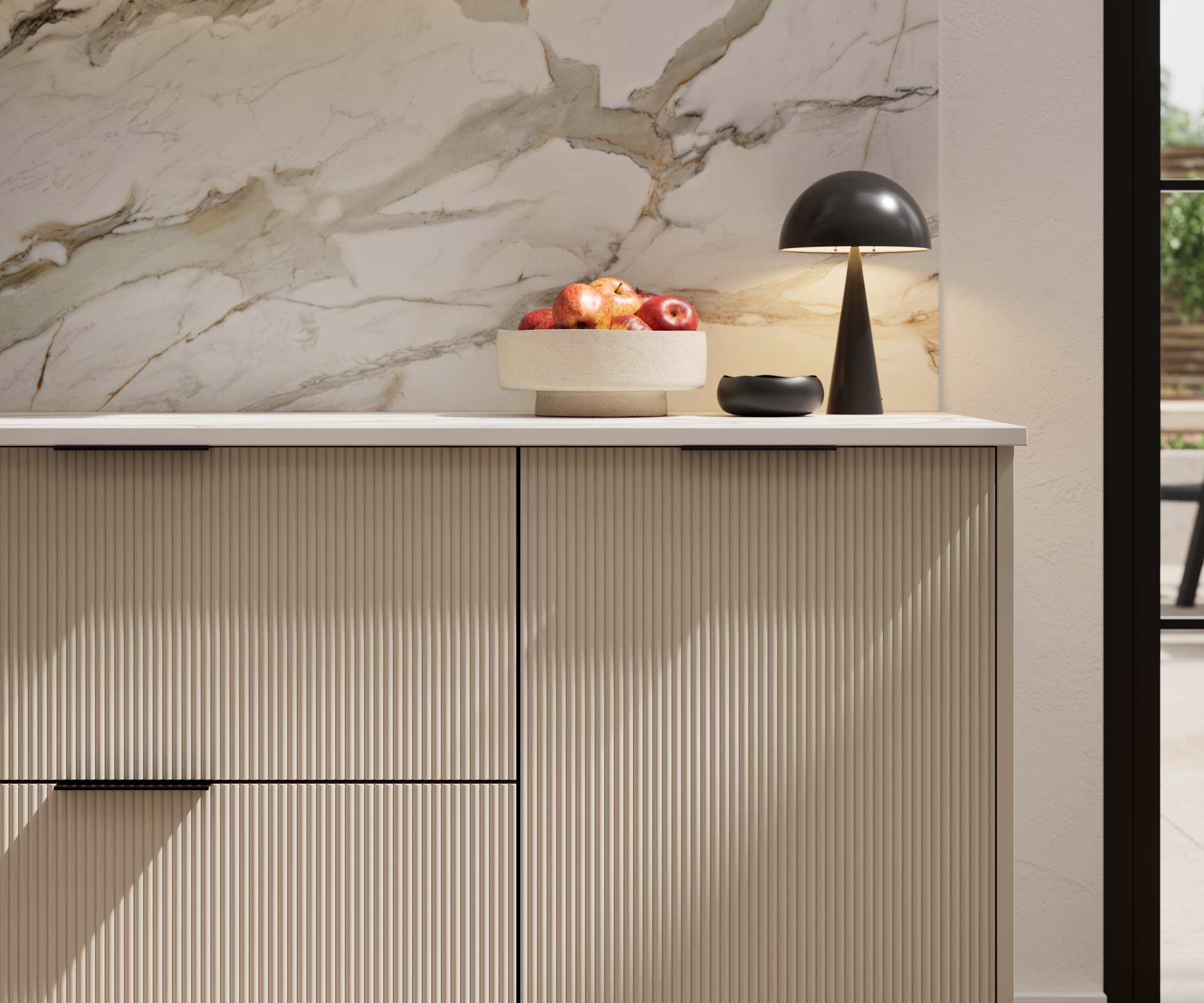 Fluted front kitchen Reed from Magnet in neutral shade Pebble Path, with a marbled splashback and black handles, herringbone wood flooring.
