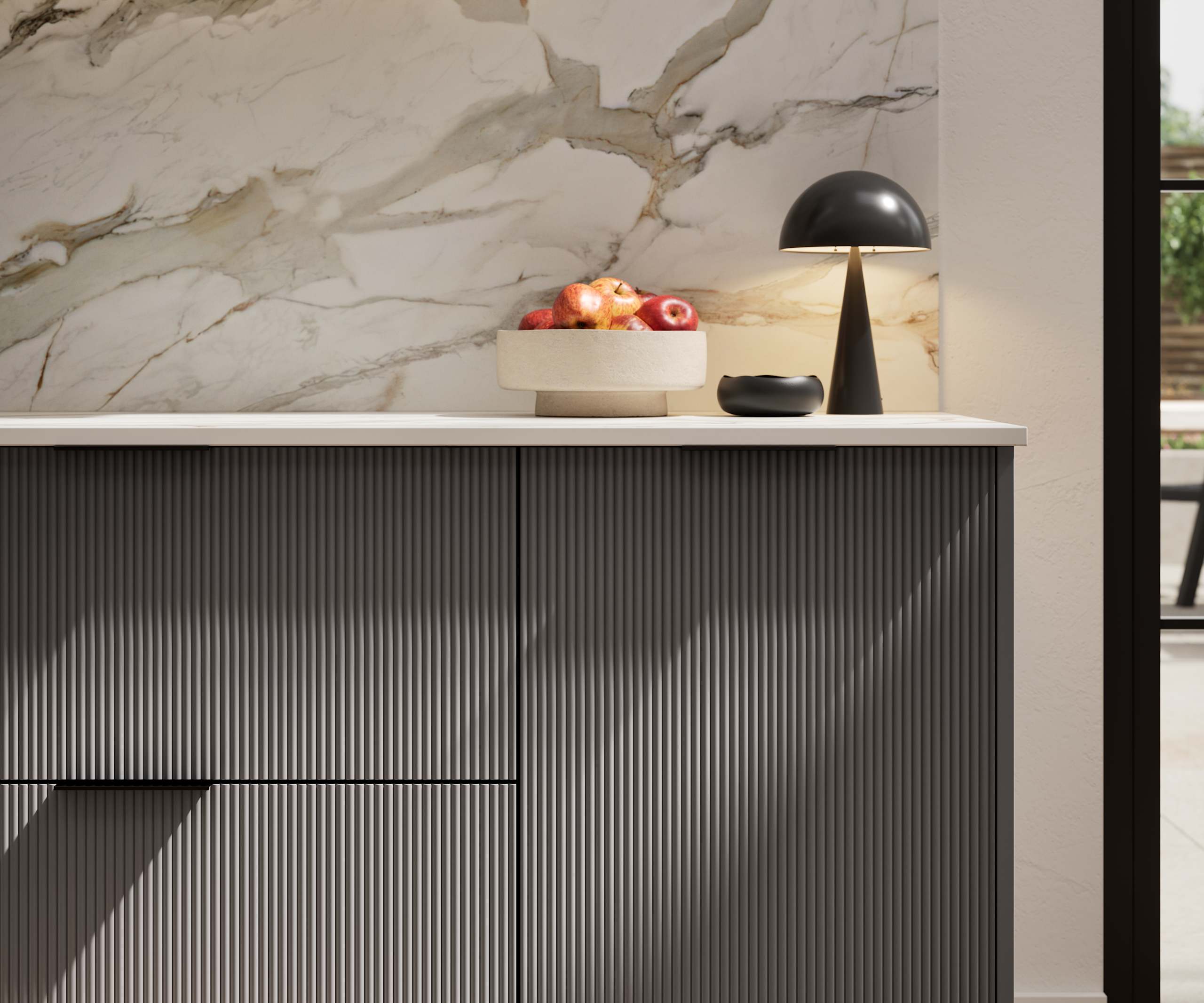 Fluted front kitchen Reed from Magnet in dark grey shade Charcoals, with a marbled splashback and black handles, herringbone wood flooring.