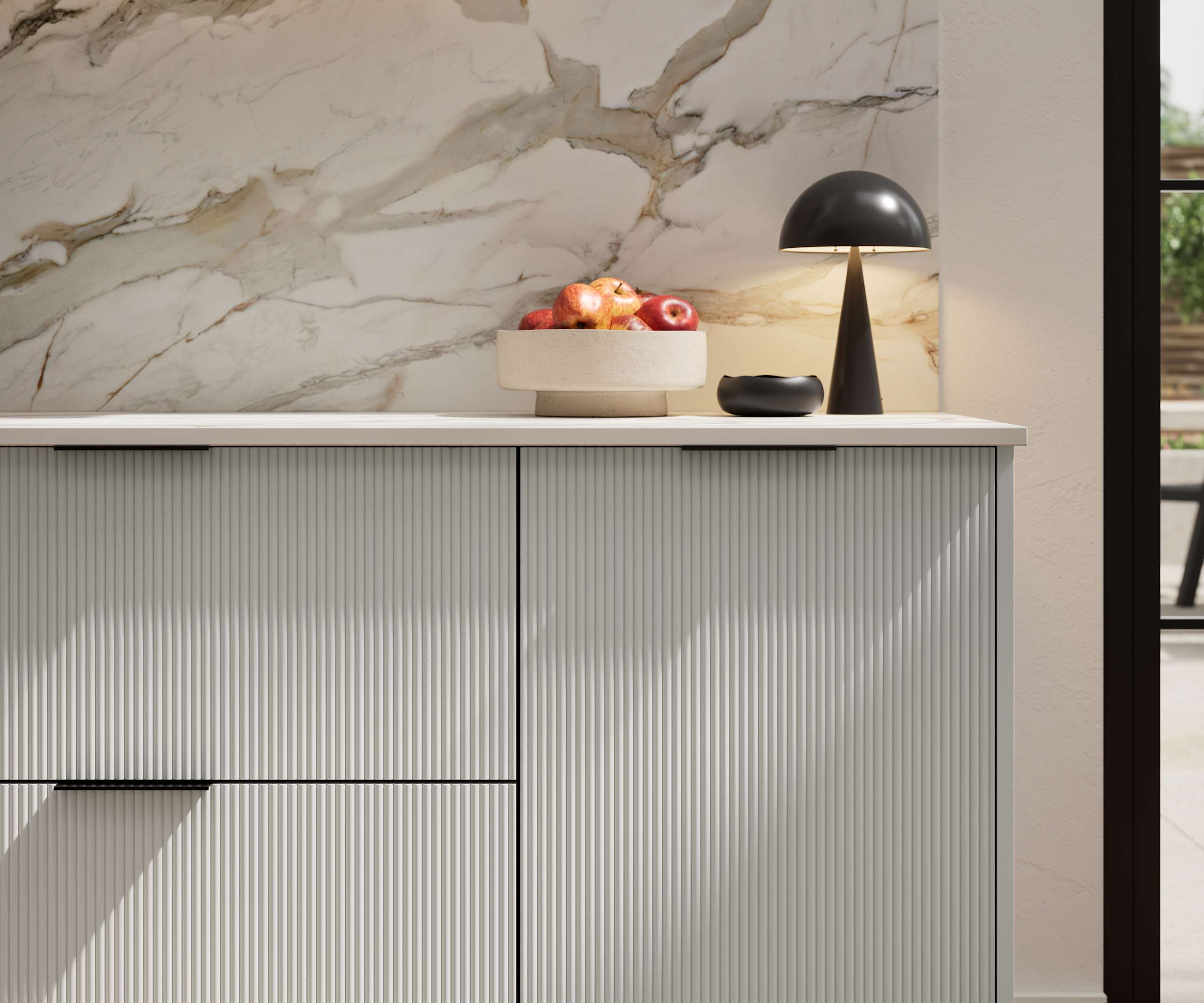 Fluted front kitchen Reed from Magnet in light neutral shade Washed cotton, with a marbled splashback and black handles, herringbone wood flooring.