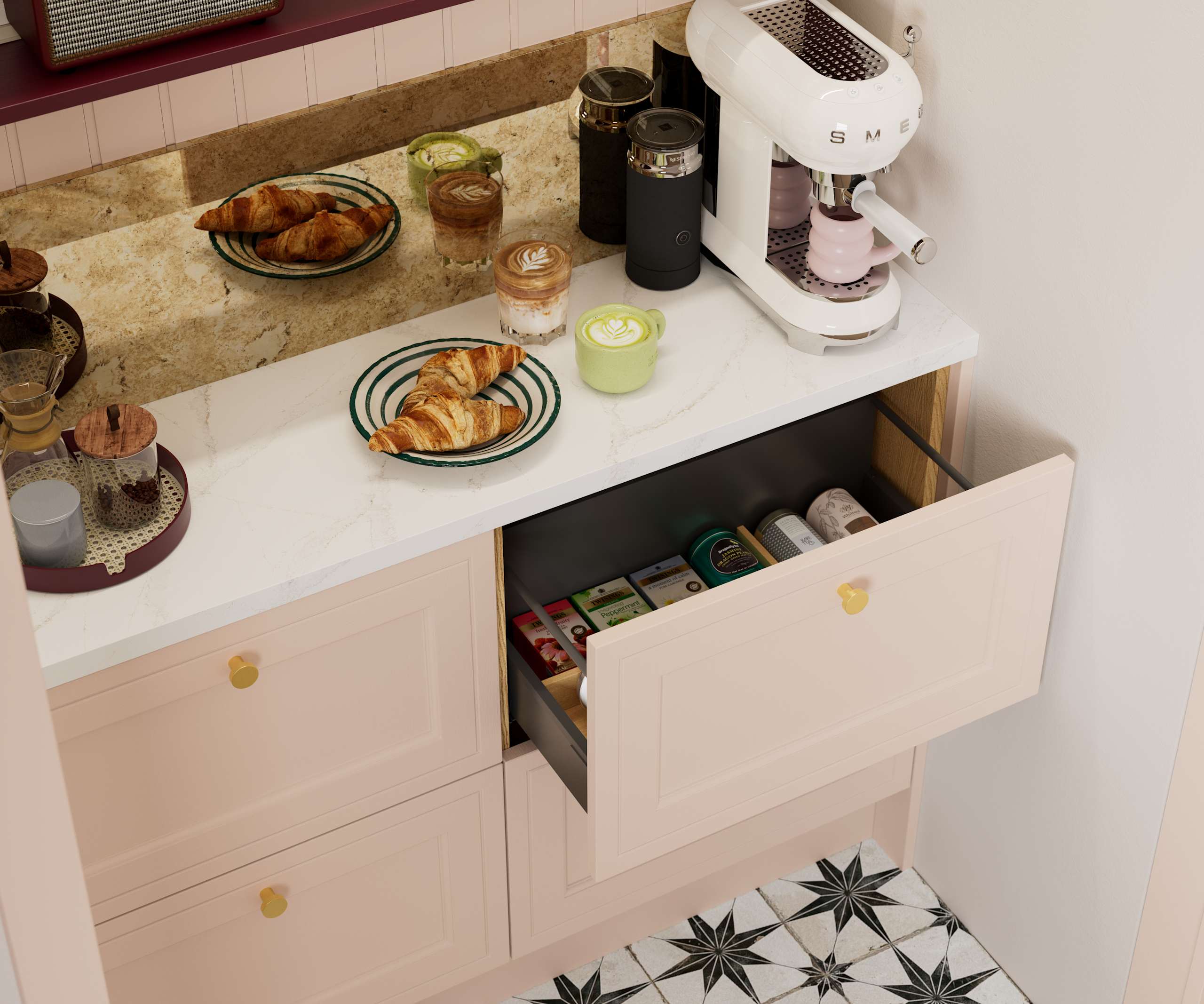 Opened drawer of teas in painted wood grain Shaker style Bewdley cabinets in light pink shade Chalk Blush, with marbled worktop, brass knobs and Smeg coffee machine on countertop.