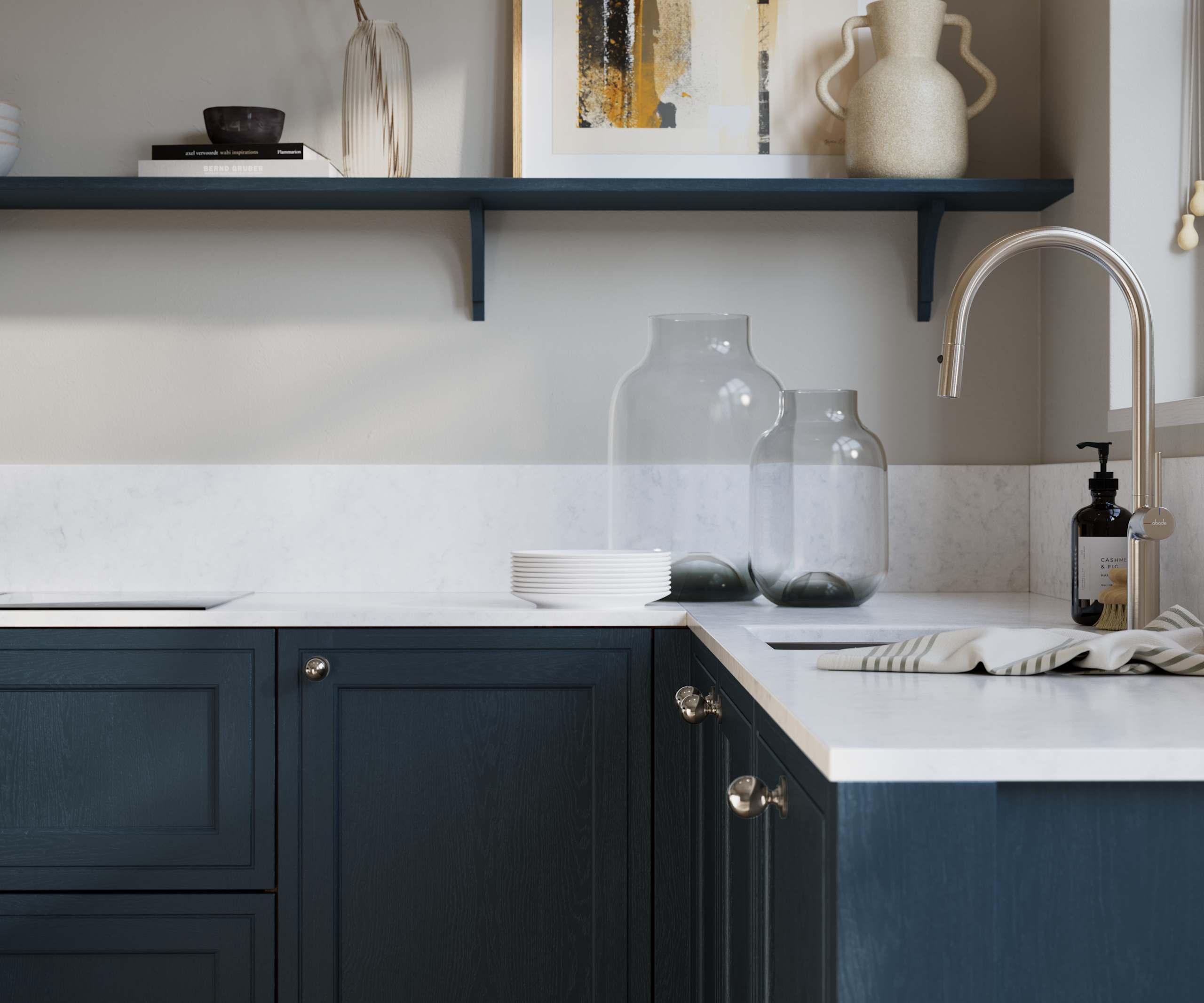 Bewdley Voyage Blue painted wood grain Shaker kitchen cabinetry with steel knobs, steel tap, white marbled worktop and matching backsplash, an open shelf on the wall above cabinets with ceramics and a vase of flowers.