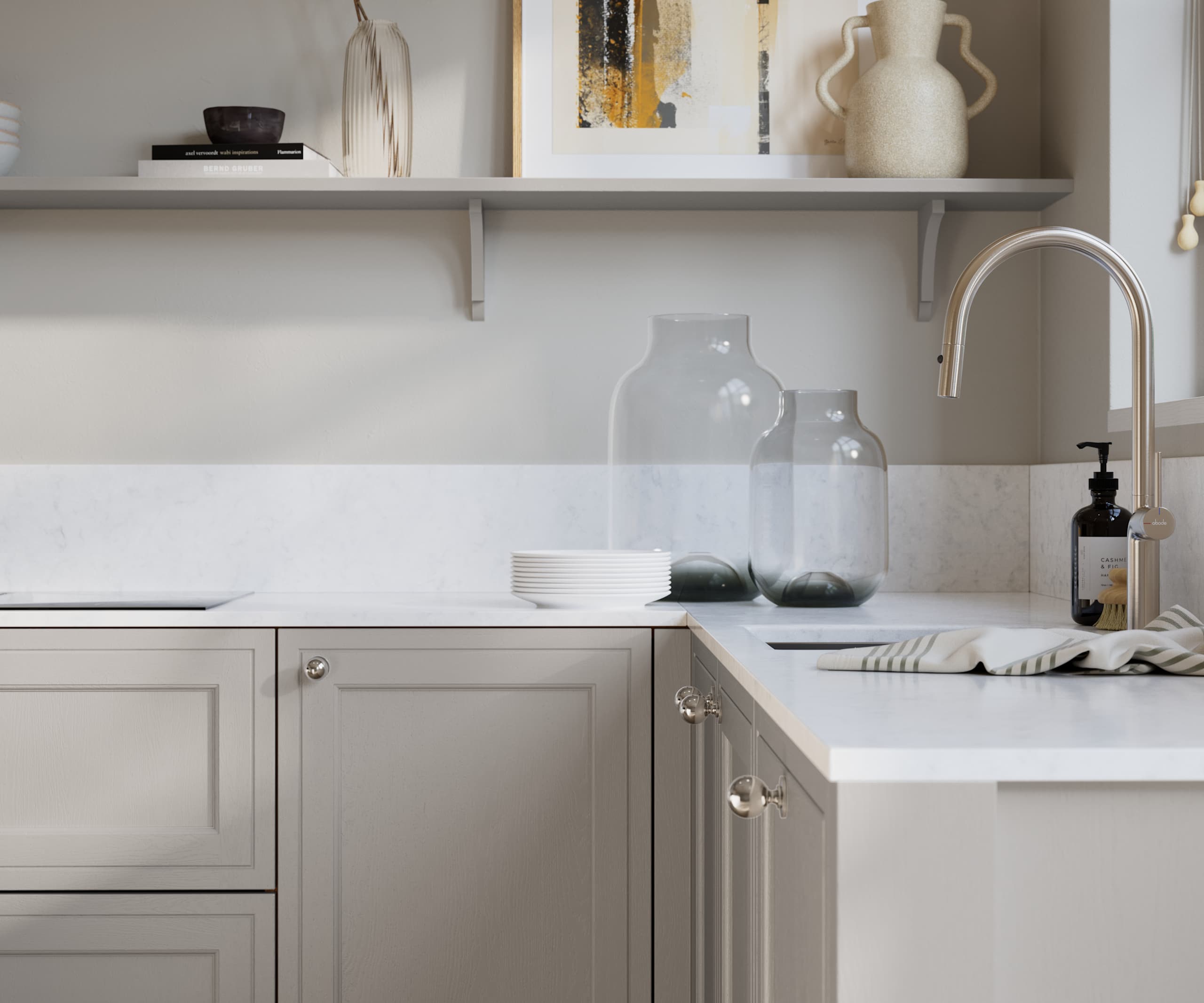 Bewdley Dove Grey painted wood grain Shaker kitchen cabinetry with steel knobs, steel tap, white marbled worktop and matching backsplash, an open shelf on the wall above cabinets with ceramics and a vase of flowers.