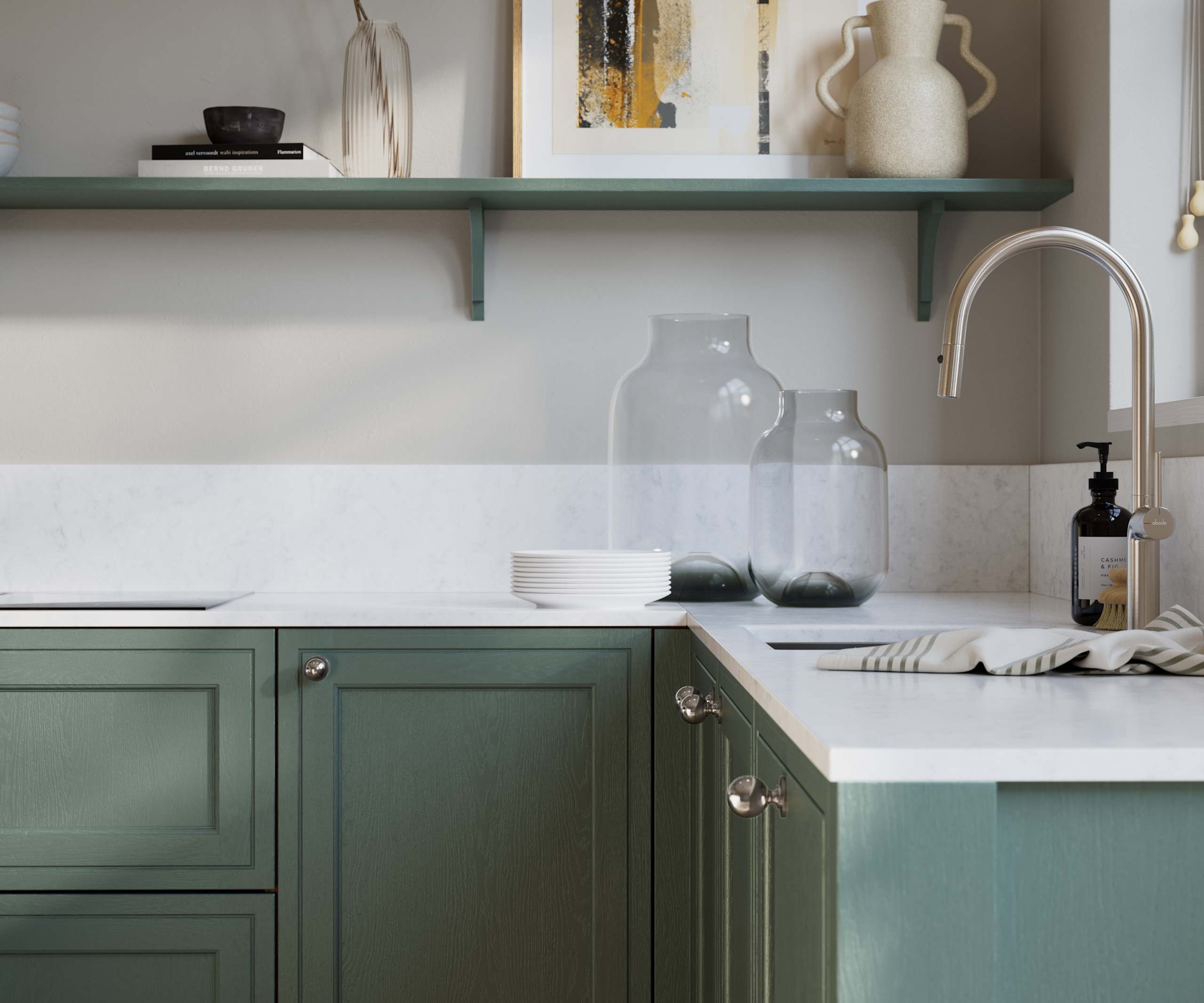 Bewdley Eucalyptus Green painted wood grain Shaker kitchen cabinetry with steel knobs, steel tap, white marbled worktop and matching backsplash, an open shelf on the wall above cabinets with ceramics and a vase of flowers.
