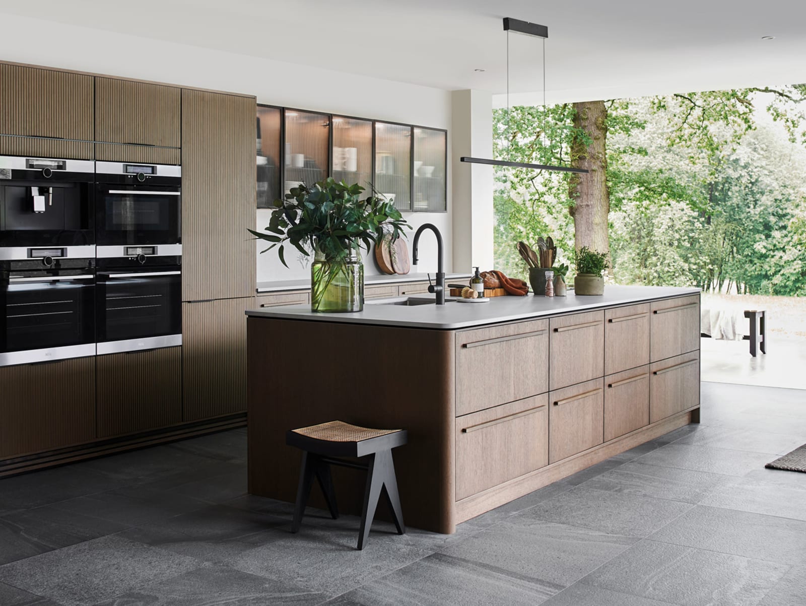 Nordic Nature. Modern wooden kitchen design with a Nordic influence. Featured floating worktops, a ribbed plinth and rounded end panels