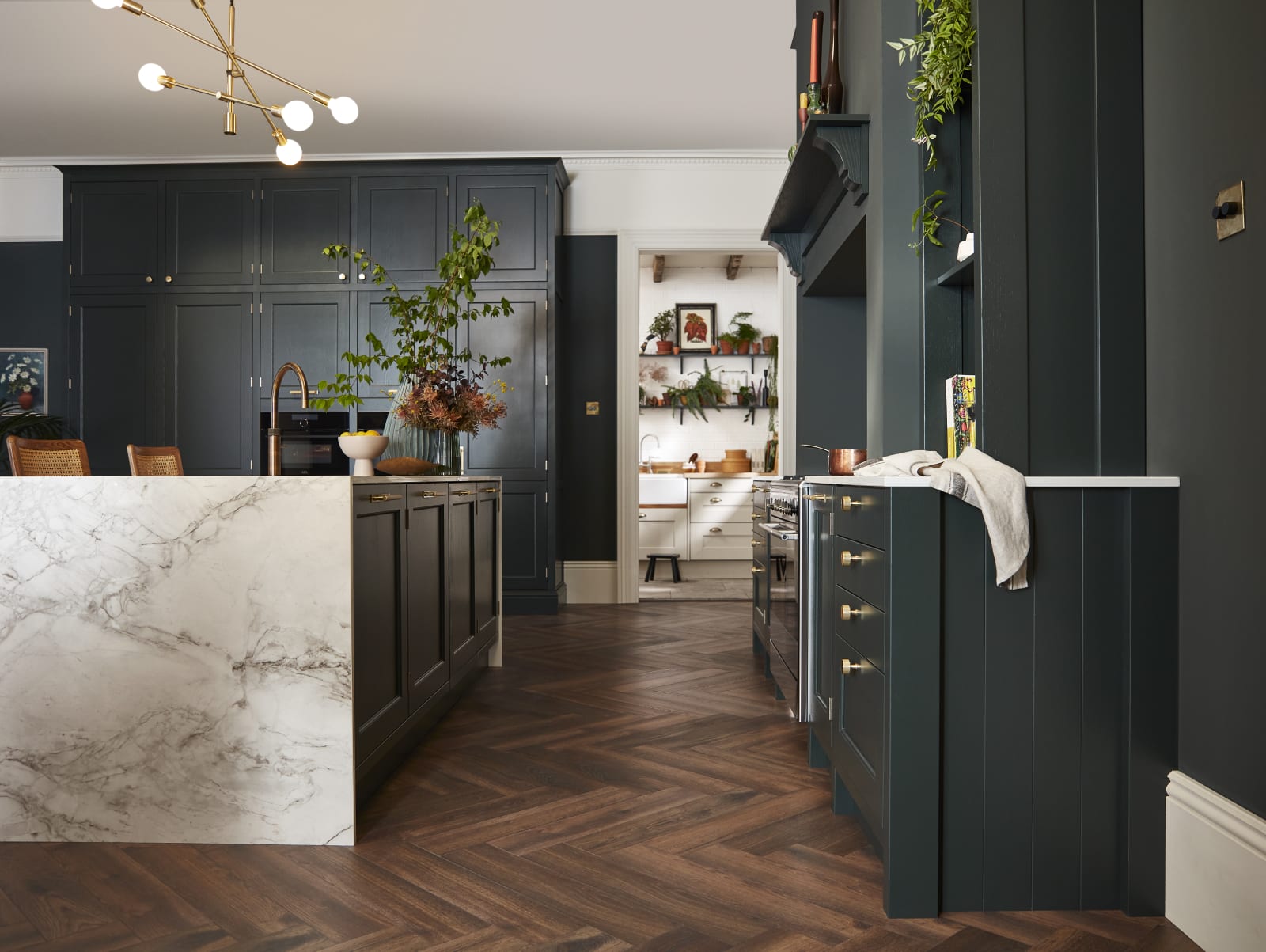 Ludlow, a traditional Shaker-style kitchen range featuring panelled doors with visible woodgrain and beading detail, in the shade Arboretum Green.