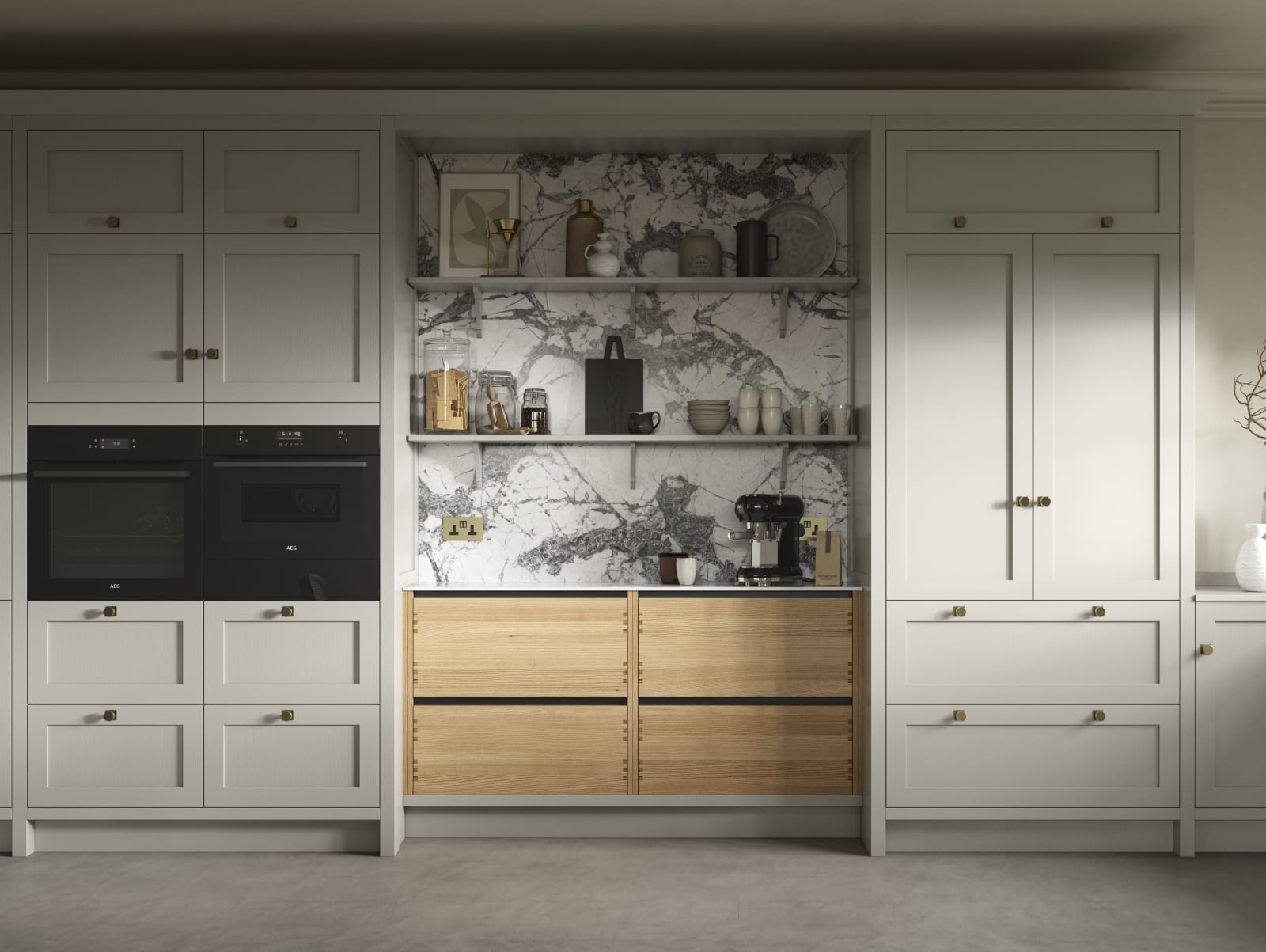 A neutral Shaker kitchen with Pebble and Nordic Craft cabinetry, marble splashback behind open shelves and paired with brass handles.