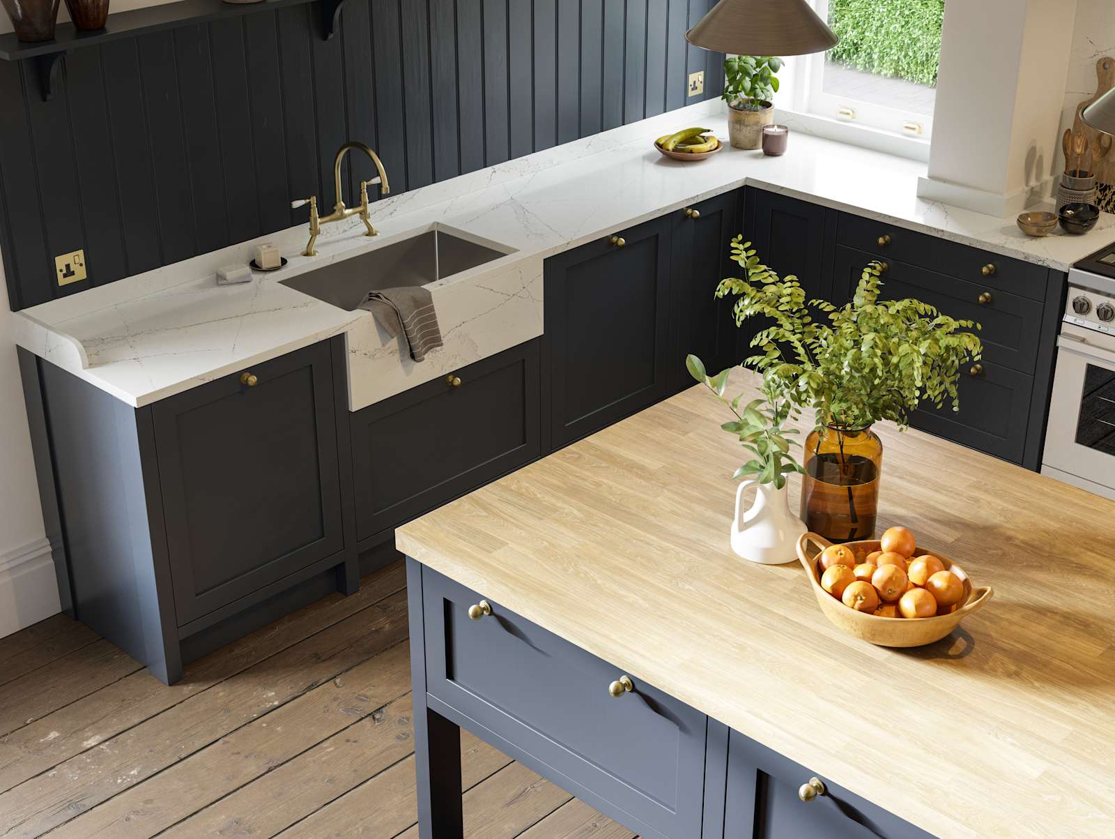 View of shaker kitchen in dark blue shade, with marble worktop and a kitchen island with light wood worktop.