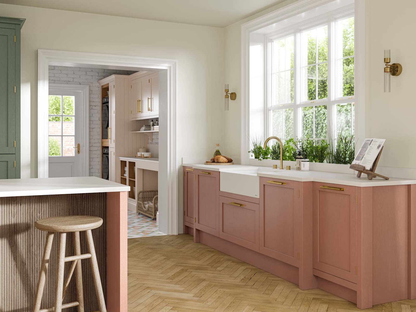 Wardley kitchen cabinetry in shades Clay and Thyme, as well as lighter beige shade Utility room visible through wide archway.