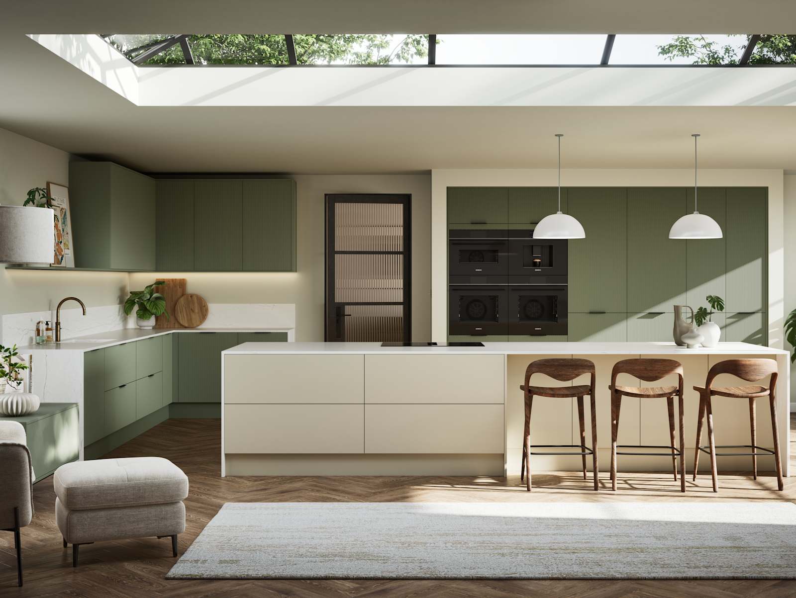 Green fluted kitchen fronts on tall cabinets with built-in appliances and black handles, light neutral shade kitchen island with white worktop and wooden barstools.