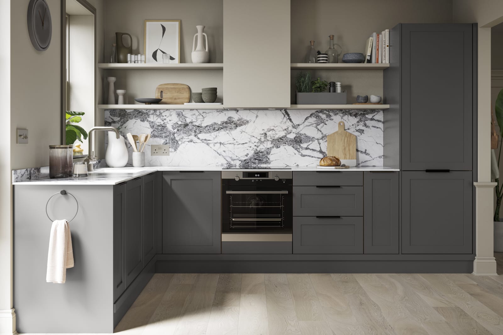 A dark grey Shaker kitchen with Charcoals cabinetry, paired with marble splashback and stylish black handles.