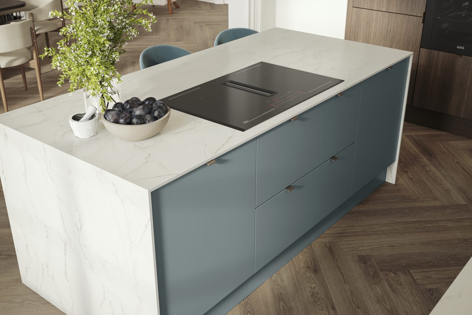 Overhead view of kitchen island with marbled dekton worktop, integrated hob and Soho Duck Blue cabinetry from Magnet.