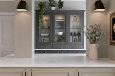 Ludlow kitchen, a Shaker door with a modern country-style in the neutral shade Pebble path paired with dark grey tall glass door display cabinets.