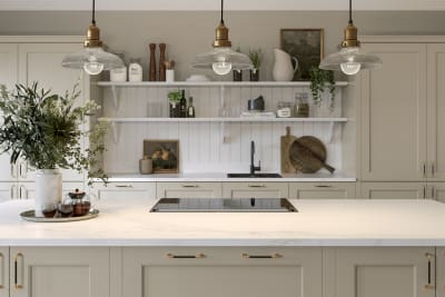 Ludlow kitchen island, a Shaker door with a modern country-style in the neutral shade Pebble path matched with brass details and white open shelves with wall panelling.