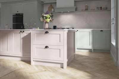 Ludlow, a traditional Shaker-style kitchen range featuring panelled doors with visible woodgrain and beading detail, in the light airy shade Seagrass.