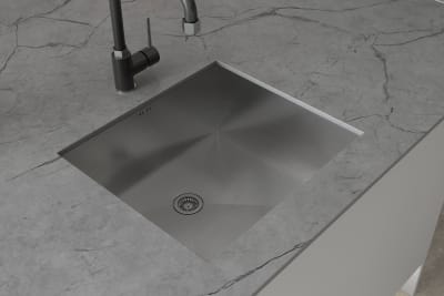 Overhead vire of matt black tap and square sink on grey Integra Nova kitchen island with marbled grey worktop.